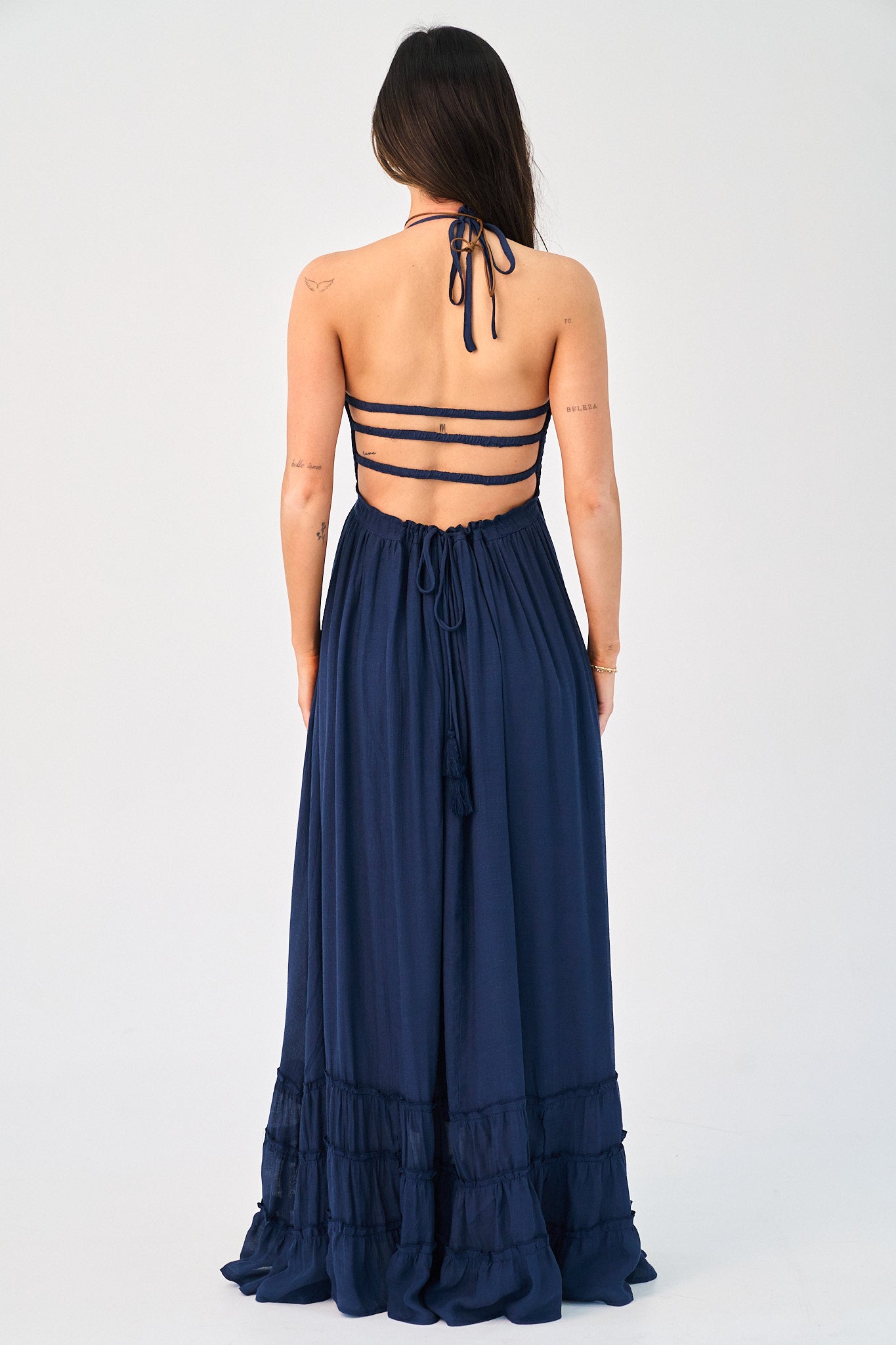 Navy blue halter neck dress with cut-out back on a white background
