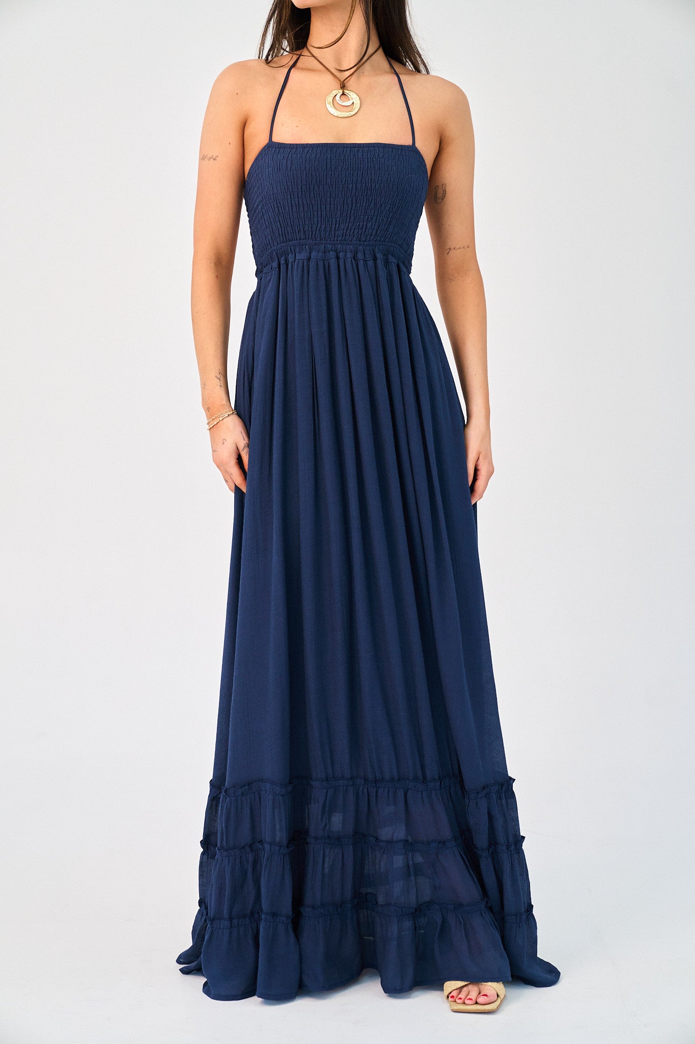 Navy blue halter neck maxi dress on a white background