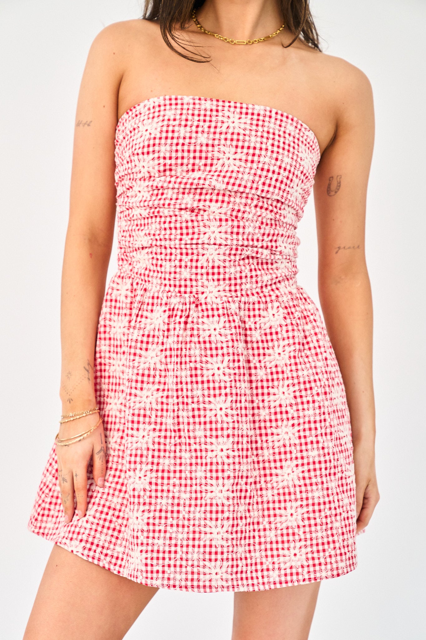 Red and white checkered strapless dress on a plain background