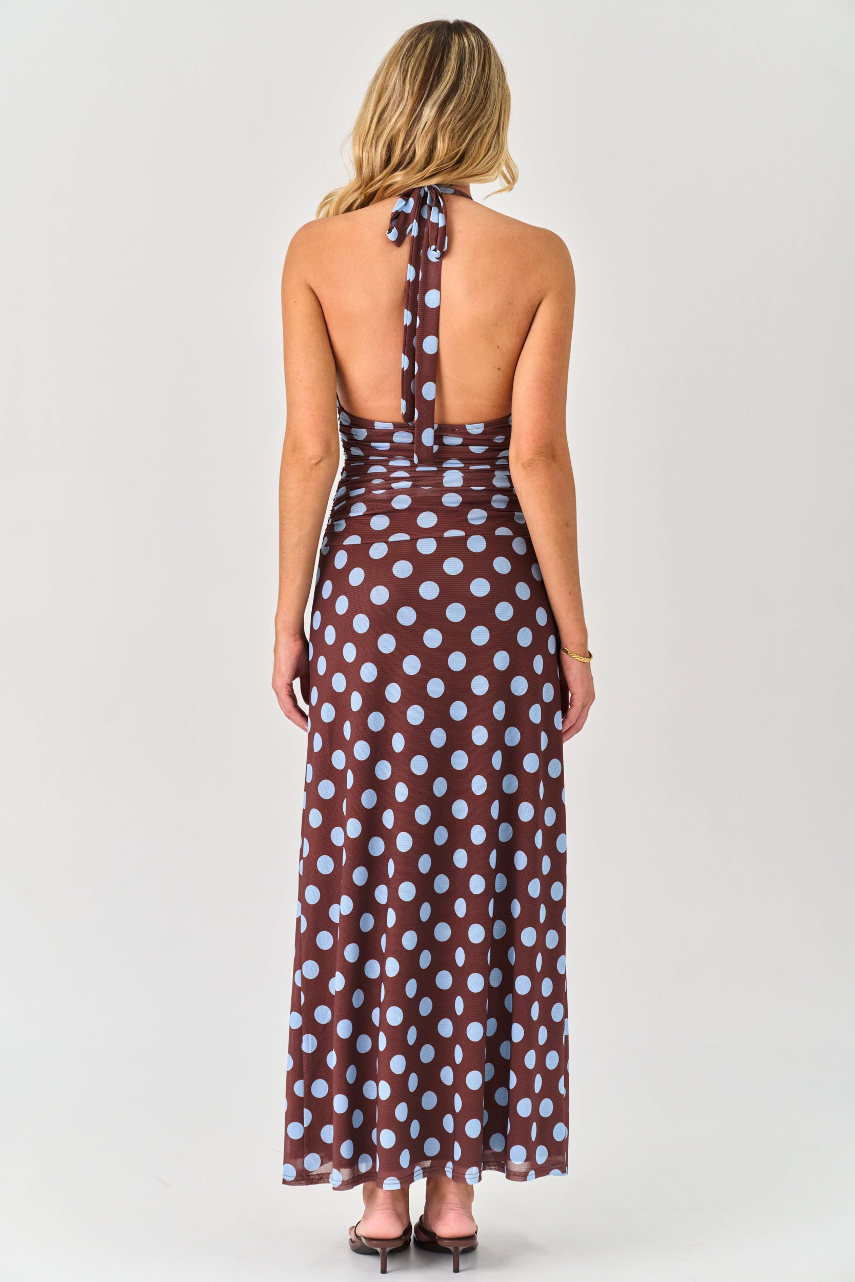 Woman wearing a polka dot dress on a white background