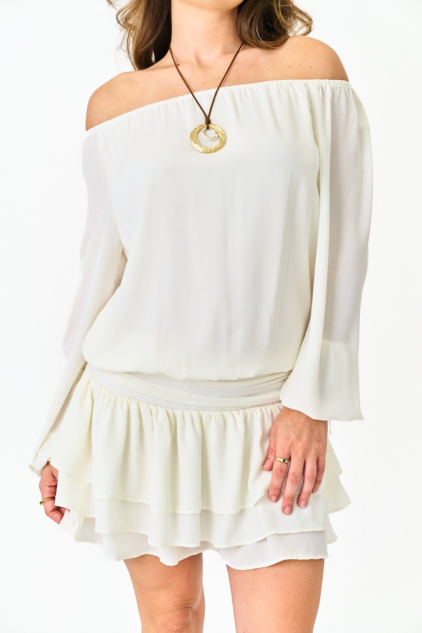 White off-shoulder dress worn by a person on a white background