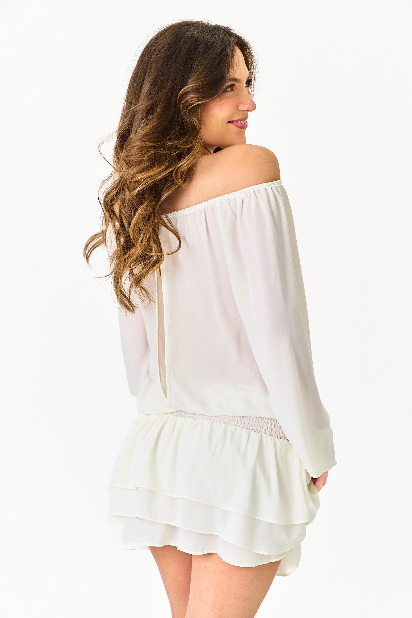 Woman wearing a white off-shoulder top on a white background