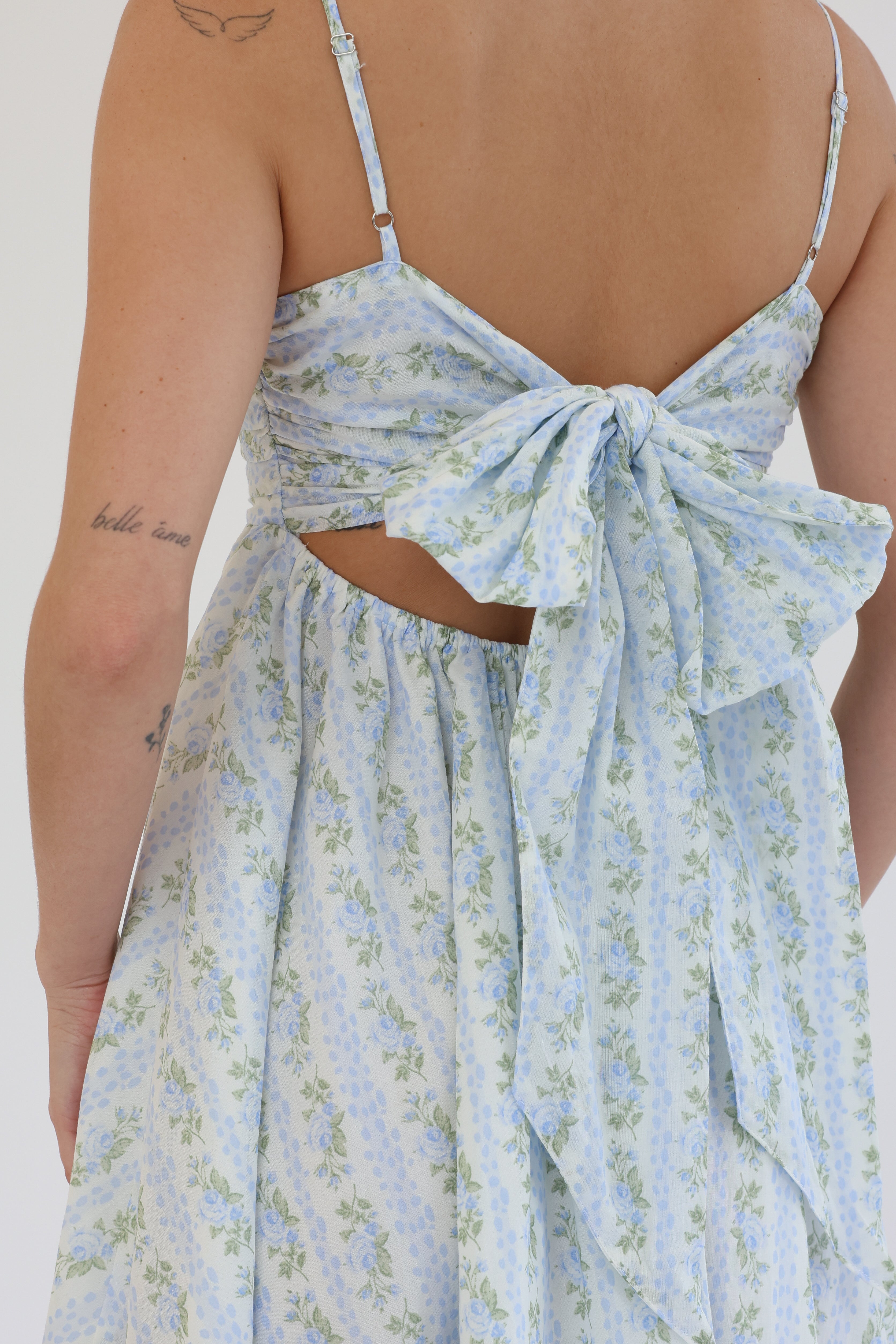 Light blue floral dress with a bow detail on a white background