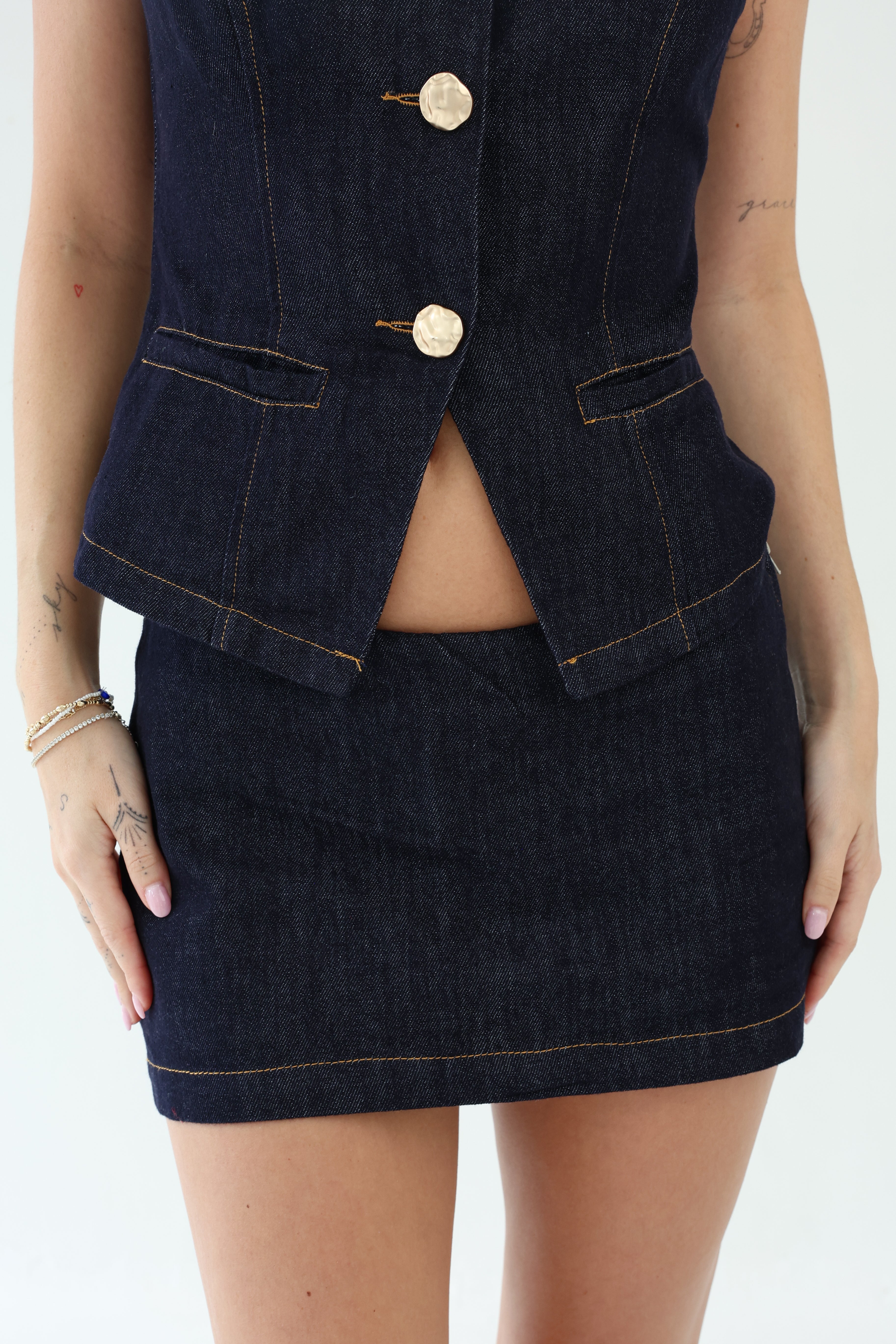 Denim vest and skirt set on a white background