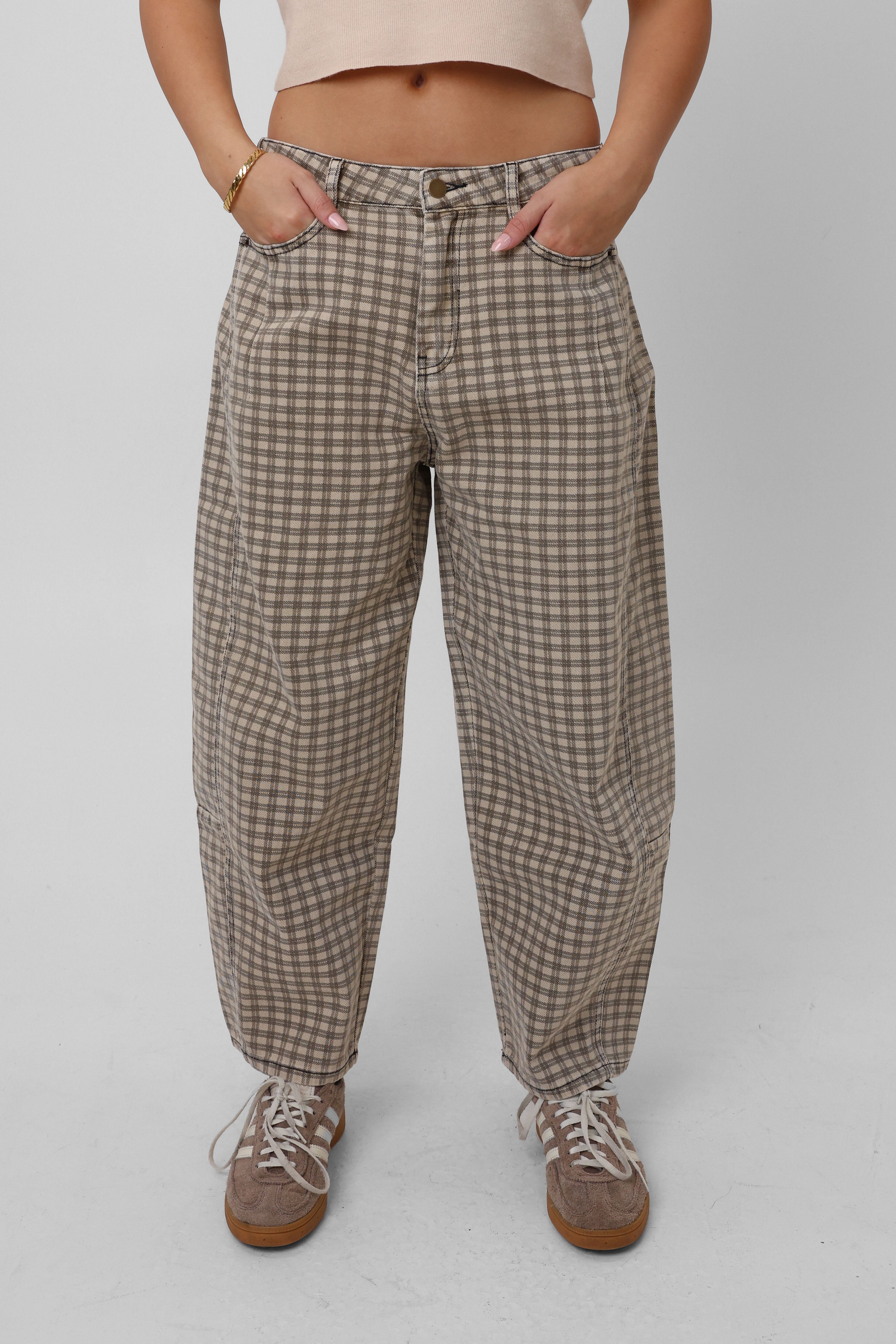 Person wearing plaid pants on a plain background
