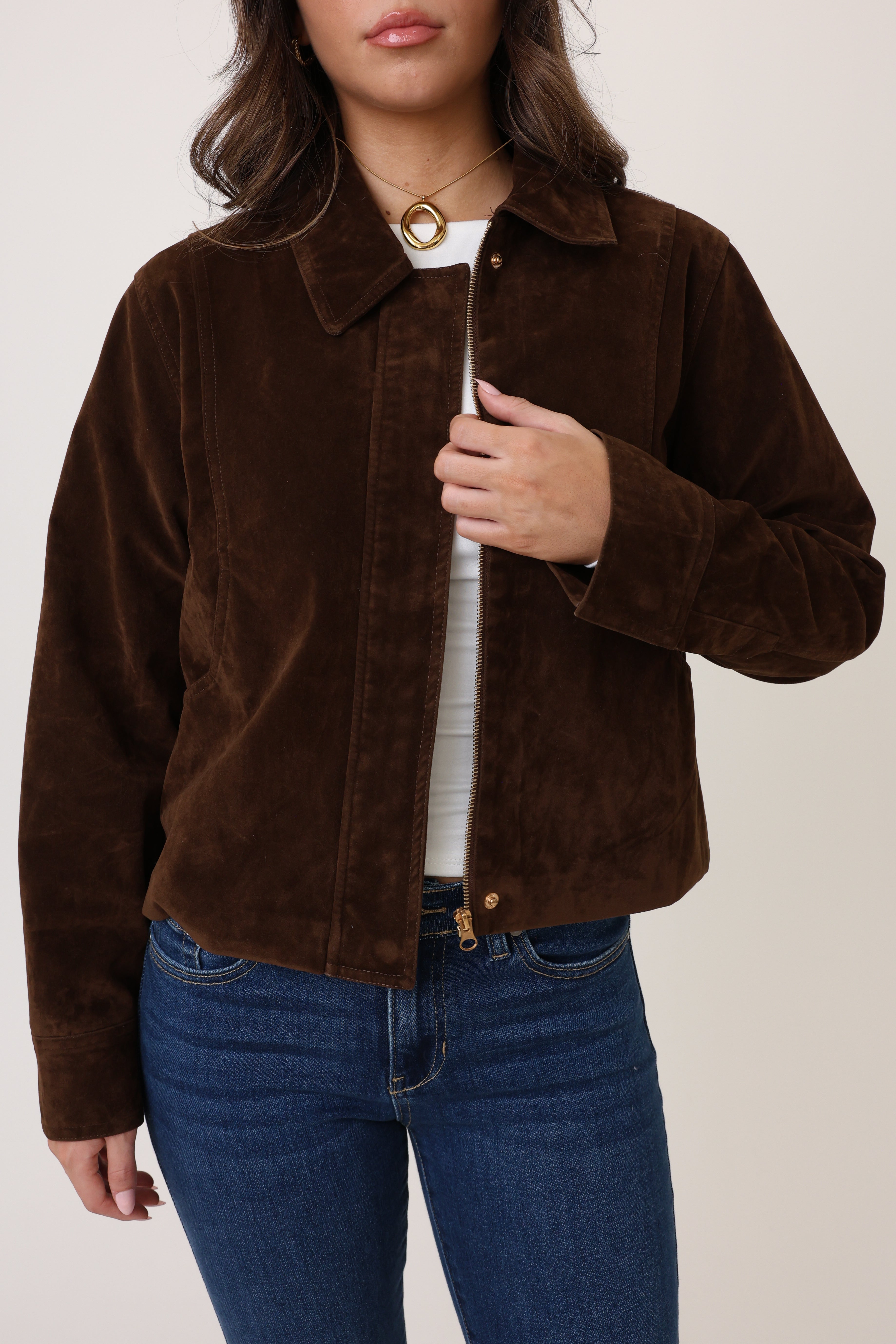 Brown corduroy jacket worn by a person on a plain background