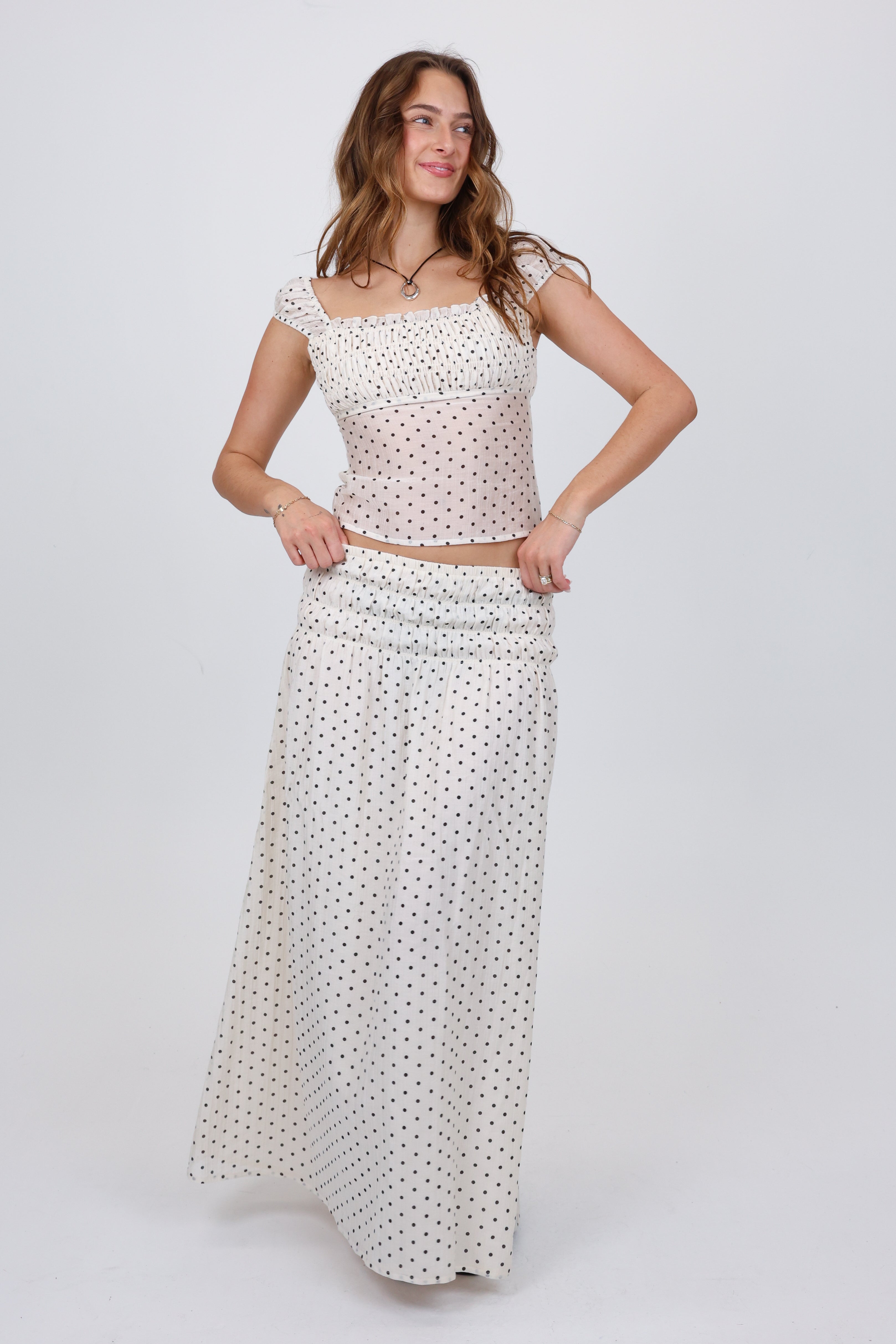 Woman wearing a polka dot dress on a white background