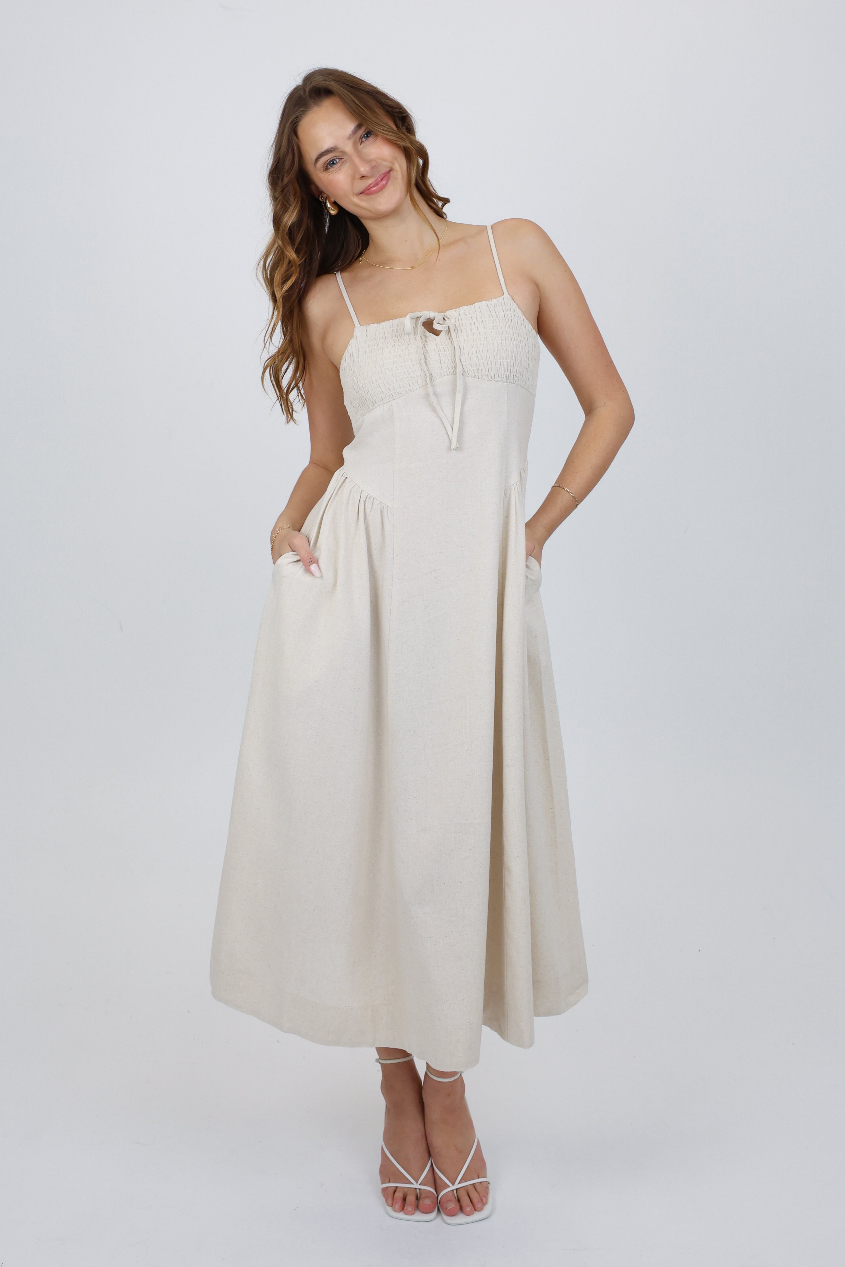 Woman wearing a beige dress on a white background