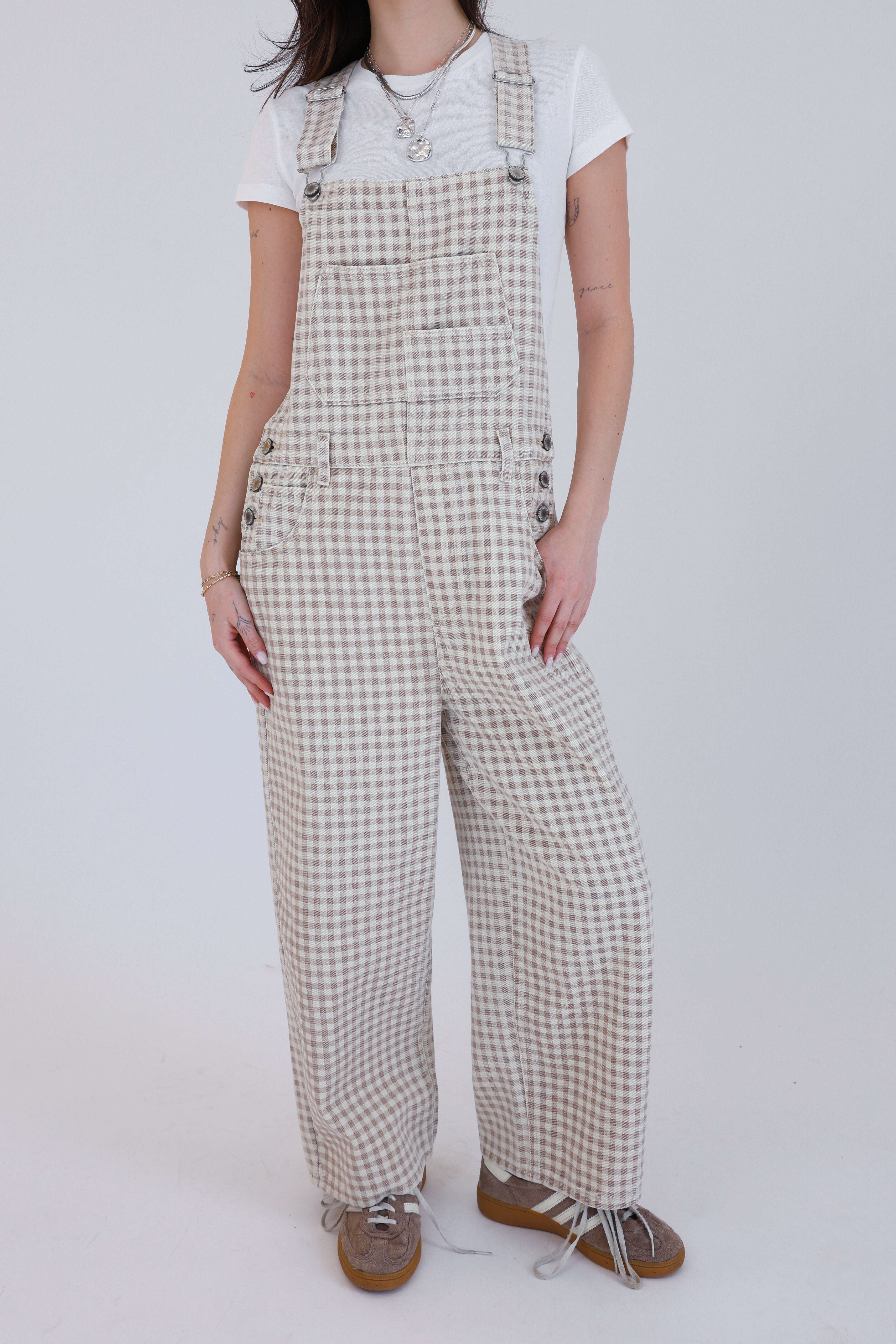 Person wearing checkered overalls on a white background