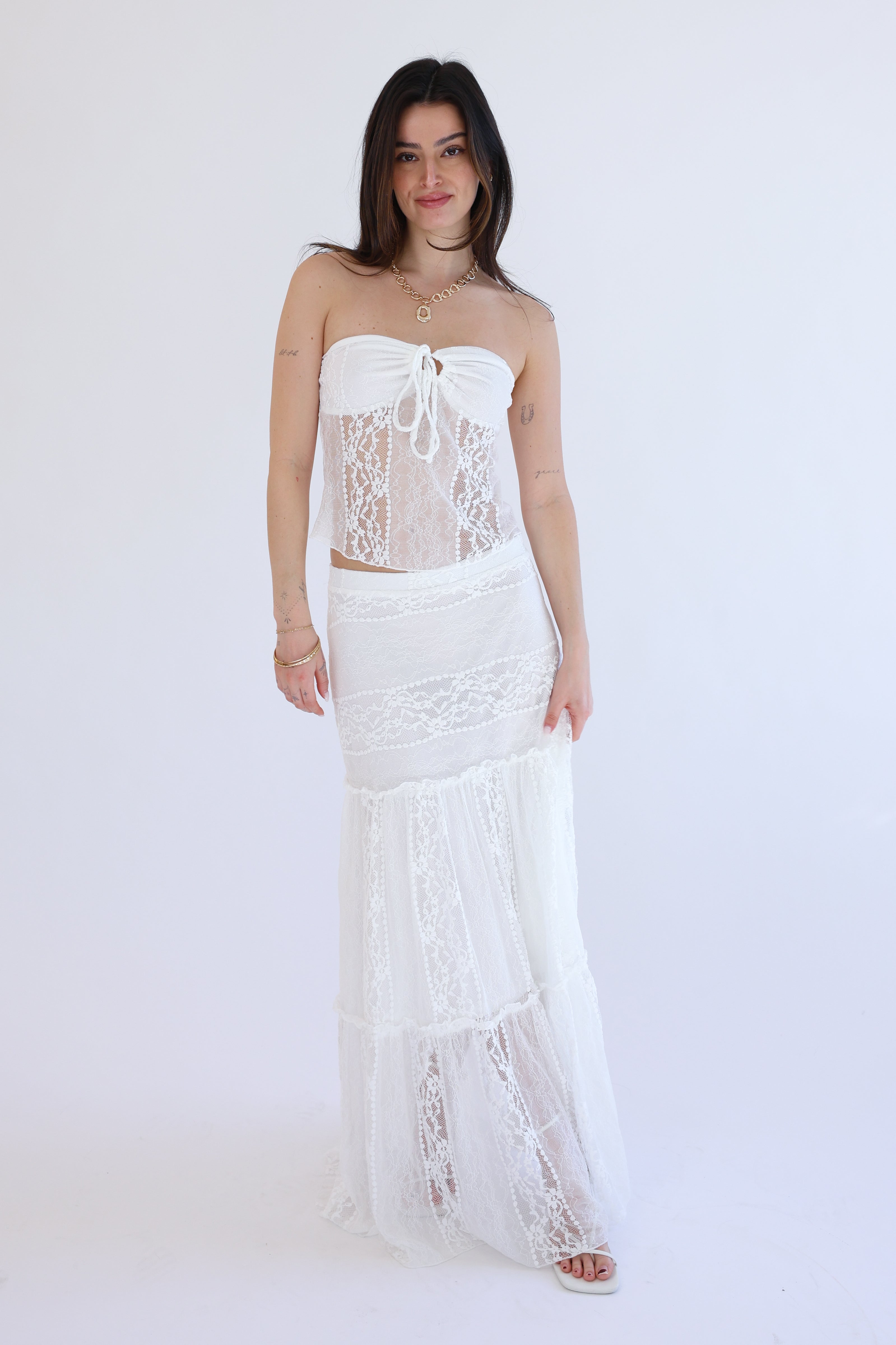 Woman wearing a white lace dress on a white background