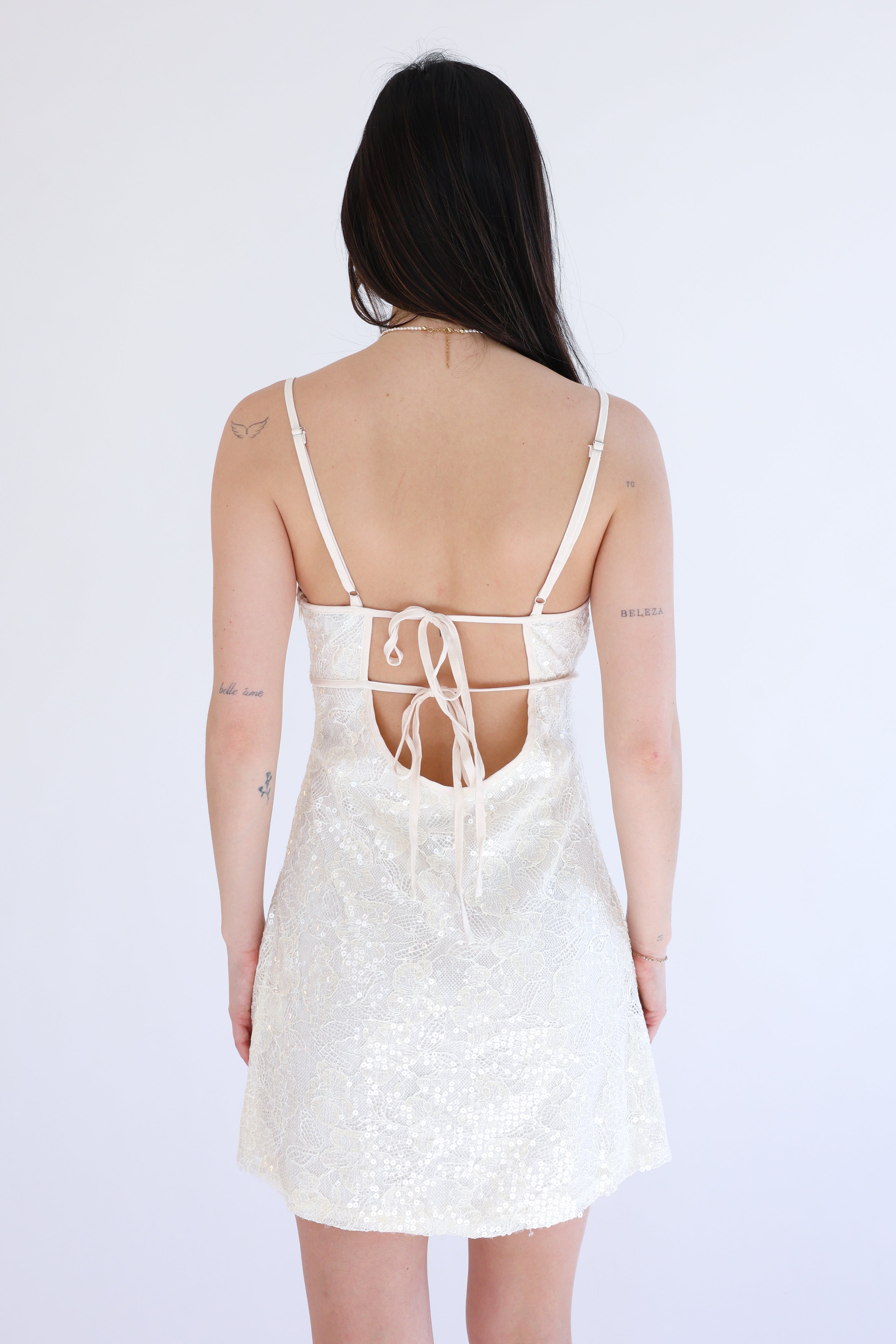 White lace dress with thin straps on a white background