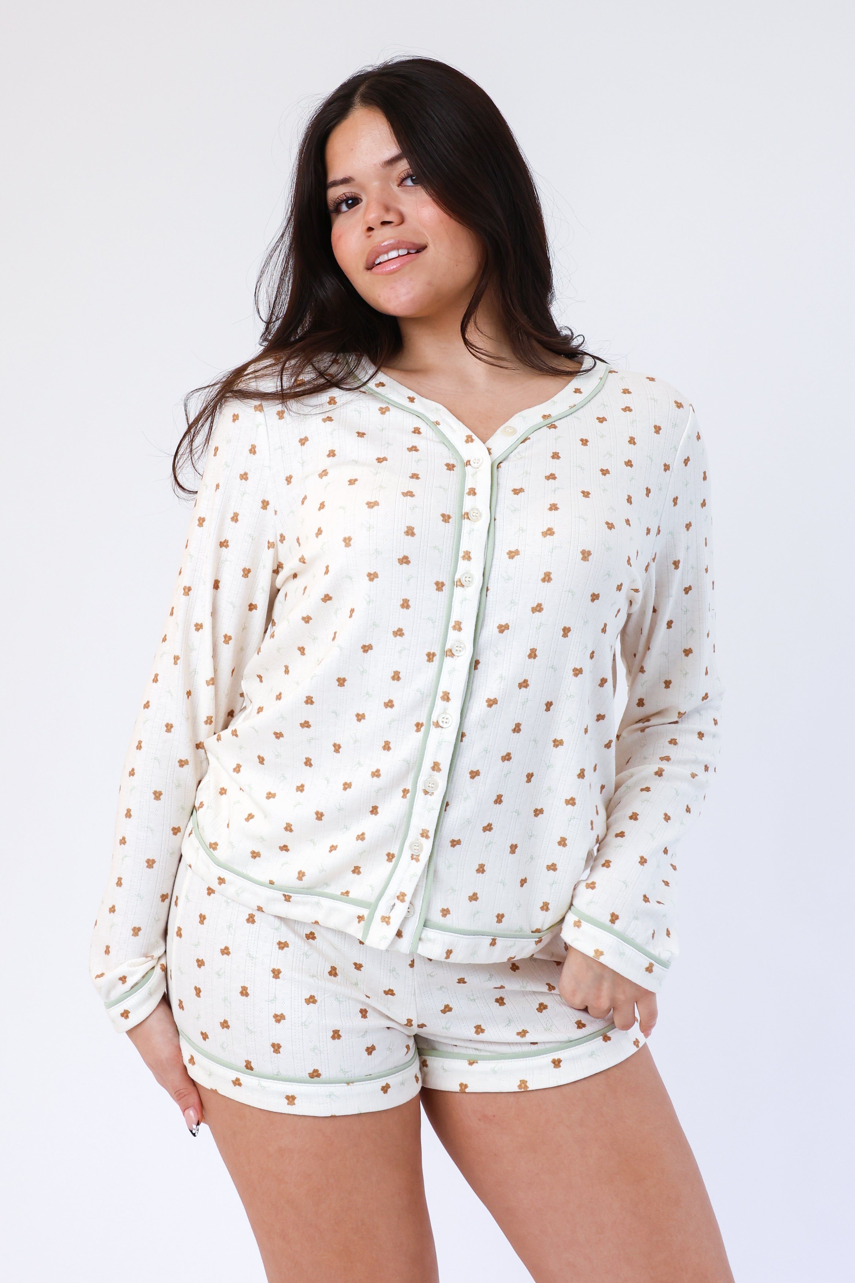 Woman wearing a polka dot pajama set on a white background
