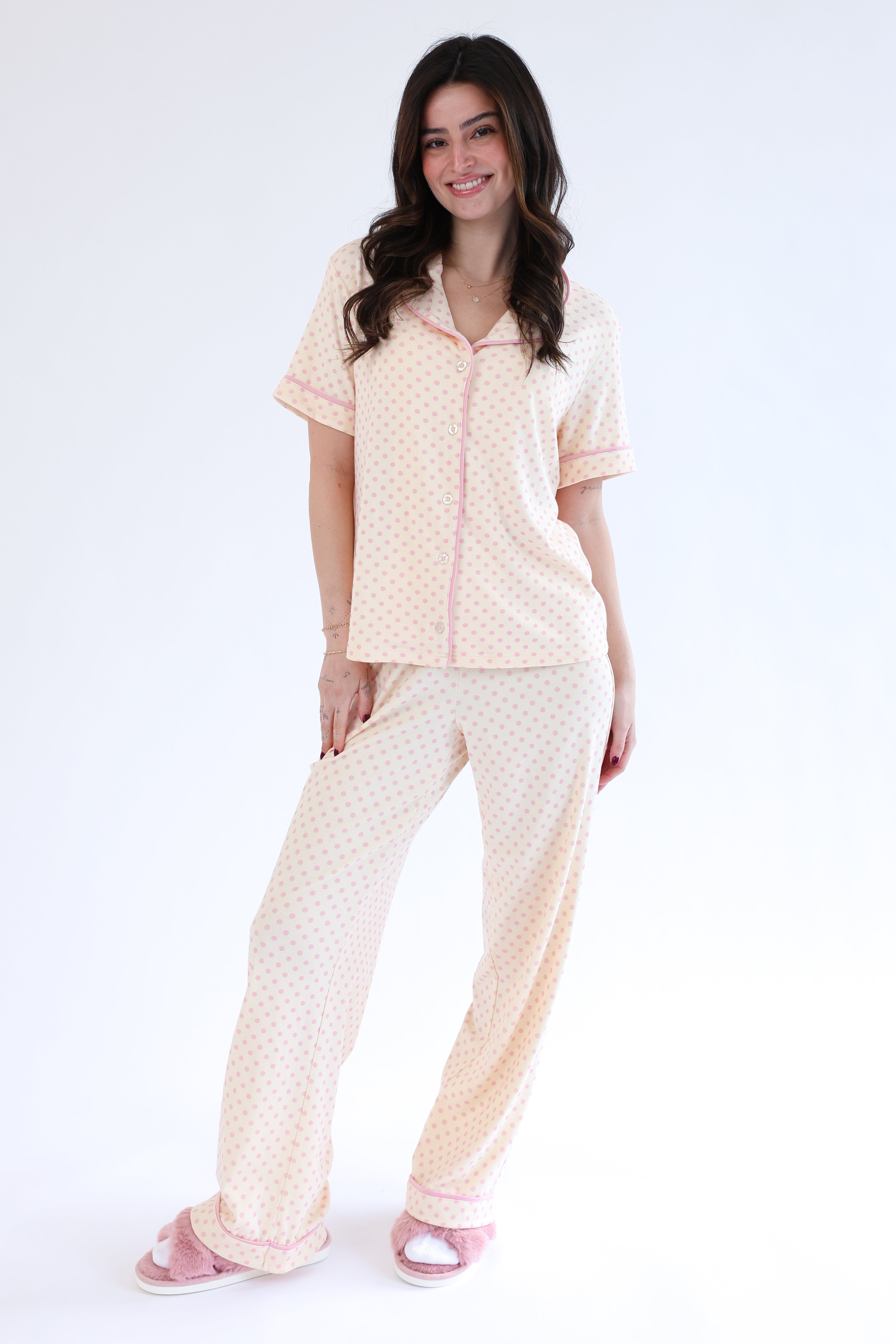 Woman wearing a matching pajama set on a white background