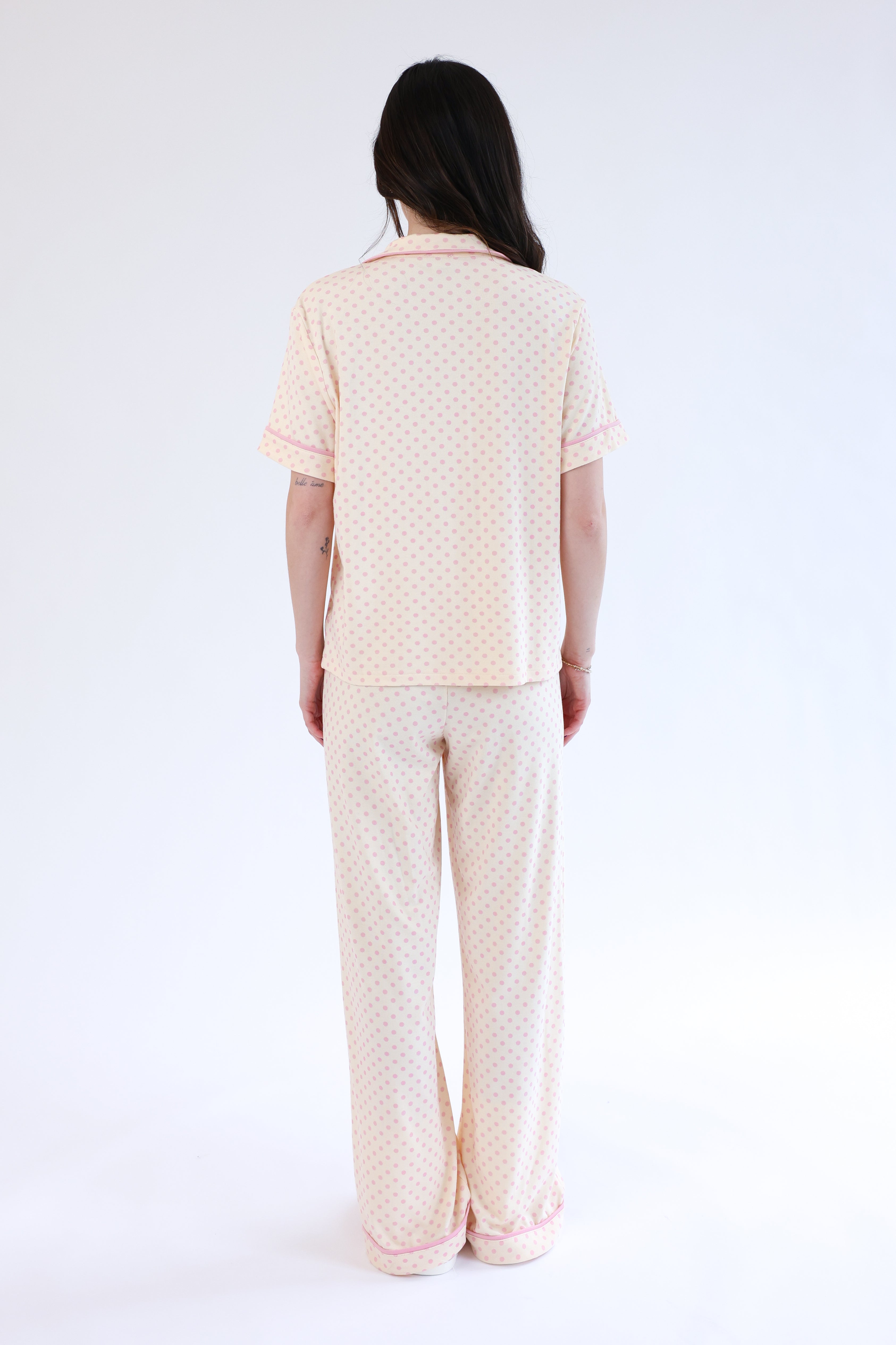Person wearing a matching pajama set with a white background