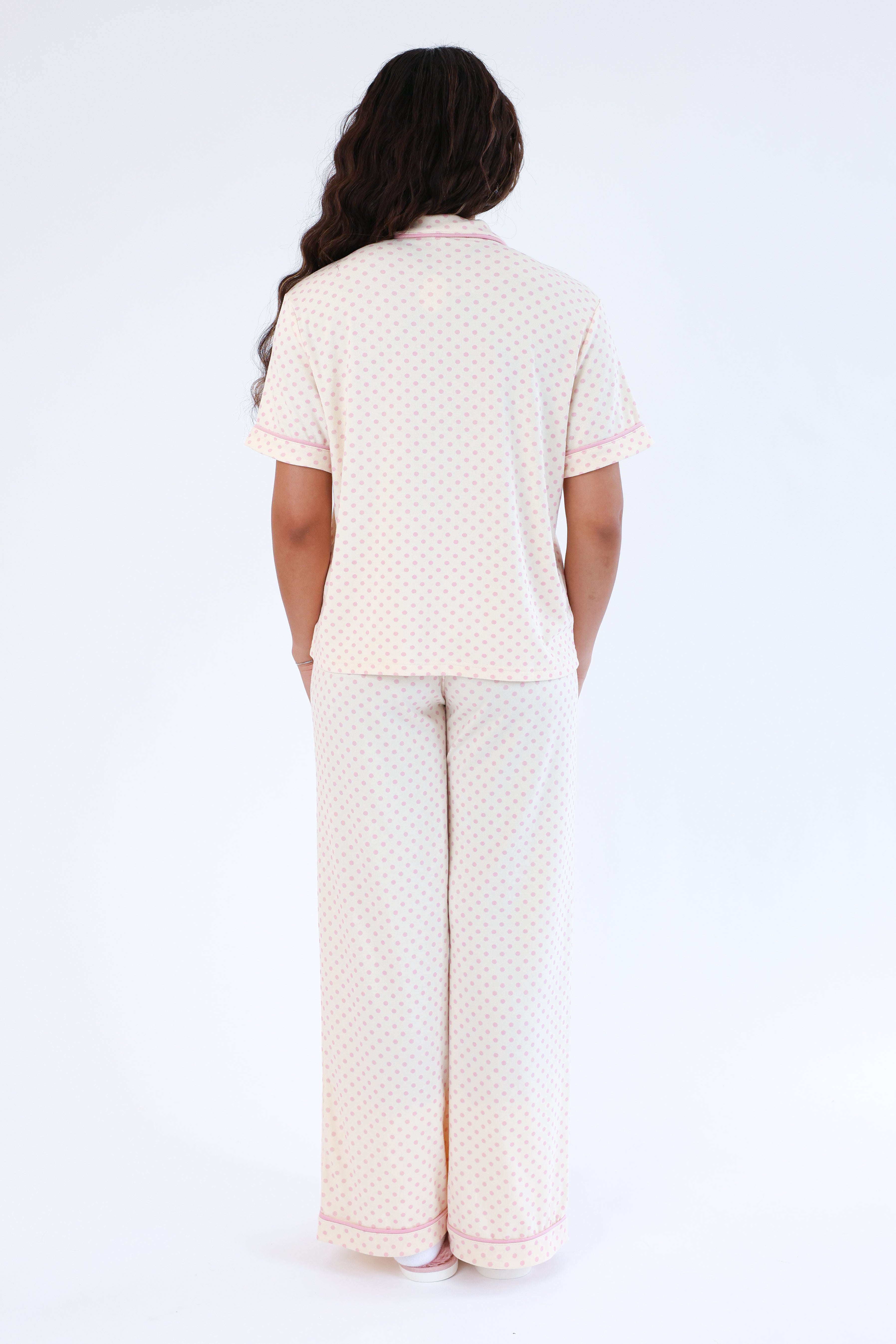 Person wearing a matching pajama set with a white background