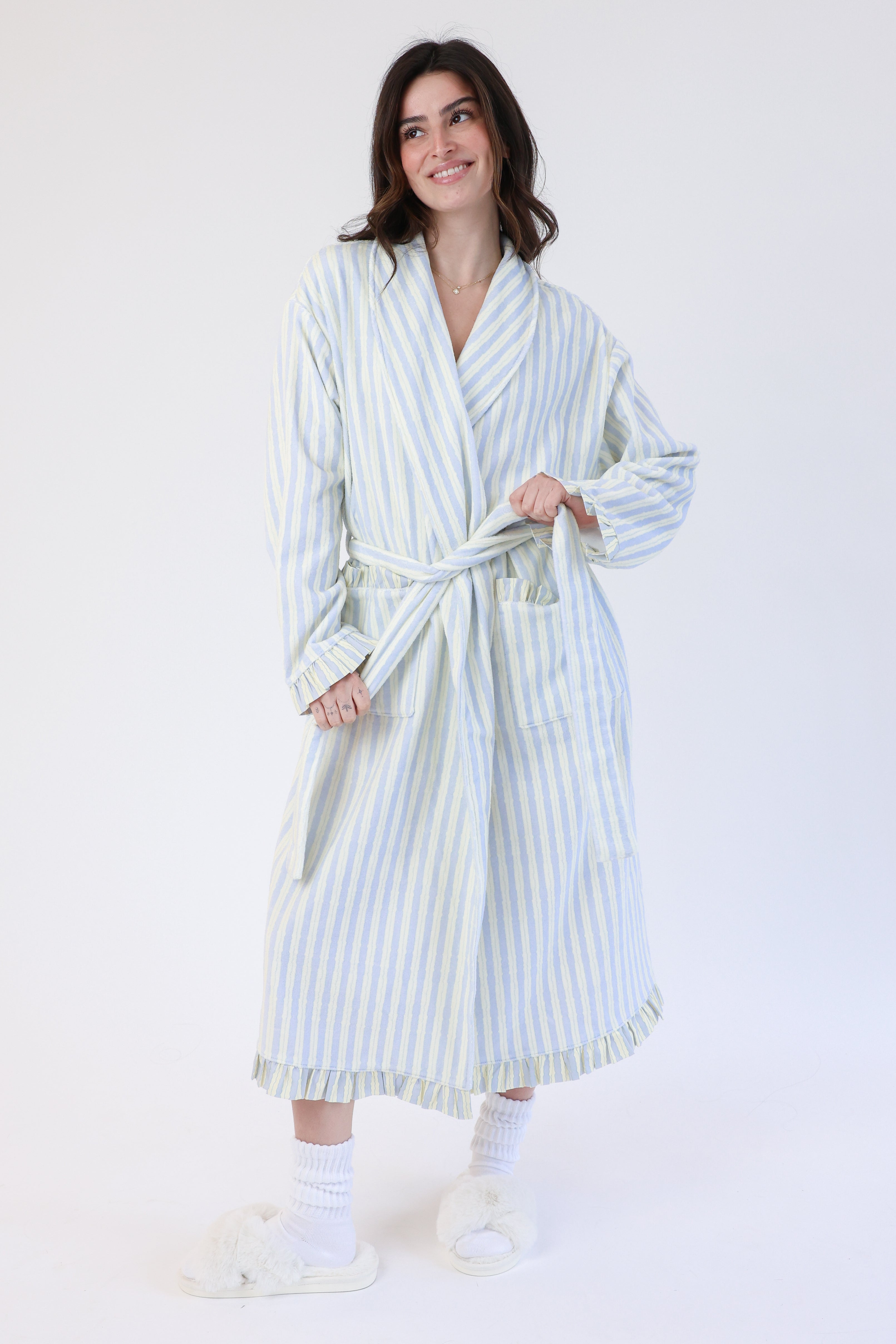 Woman wearing a striped robe on a white background