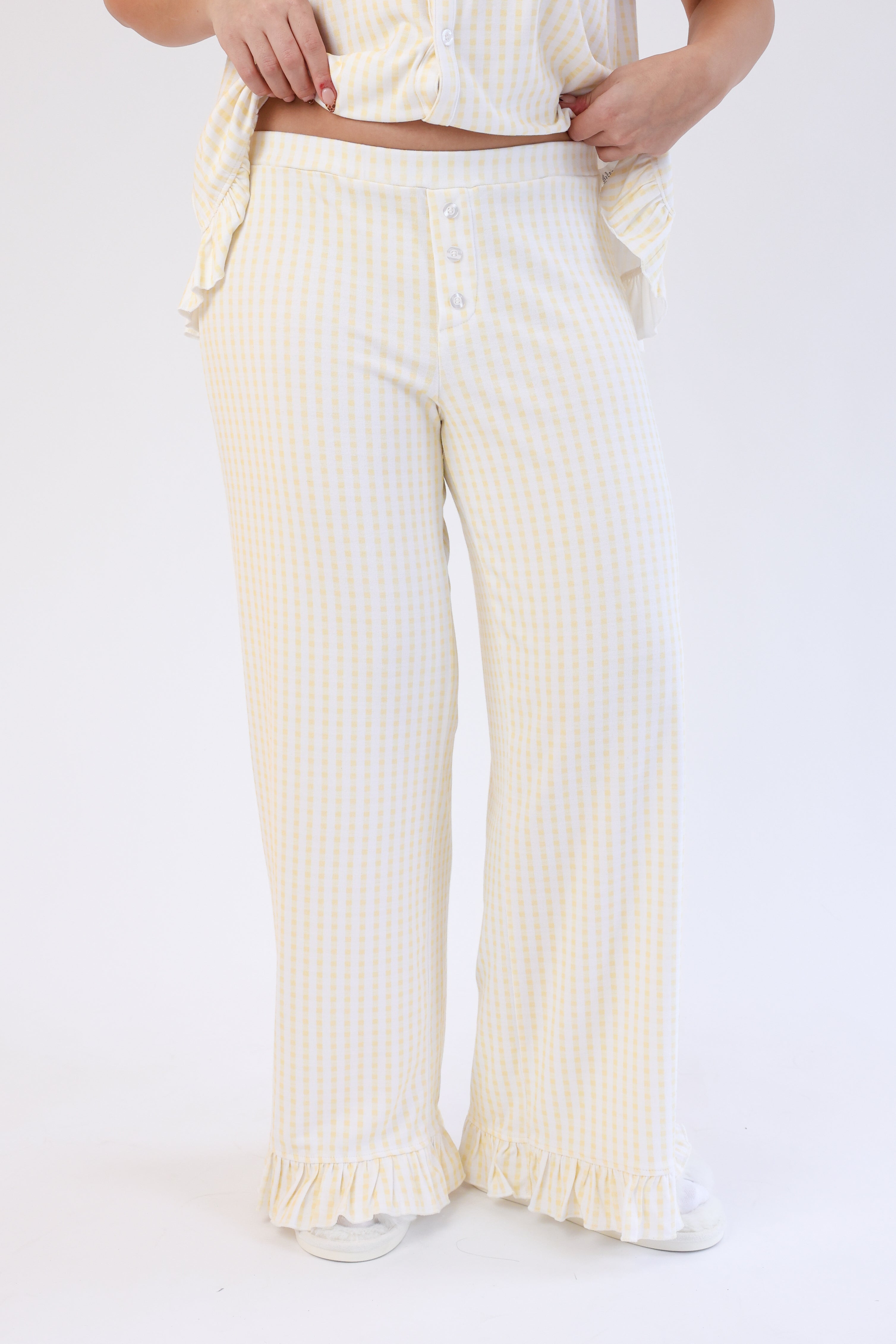 White striped pants worn by a person on a white background