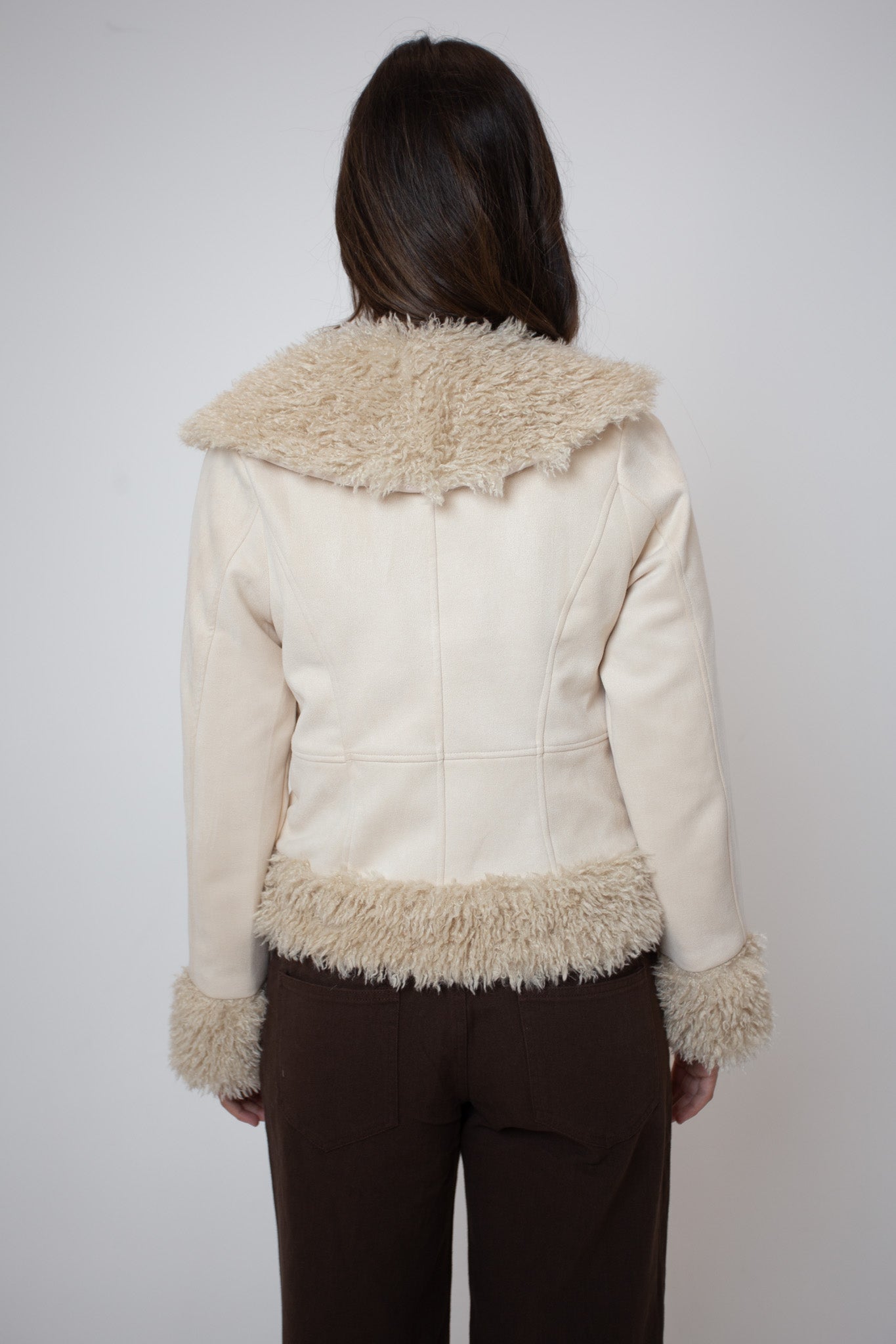 White jacket with fur trim worn by a person on a white background