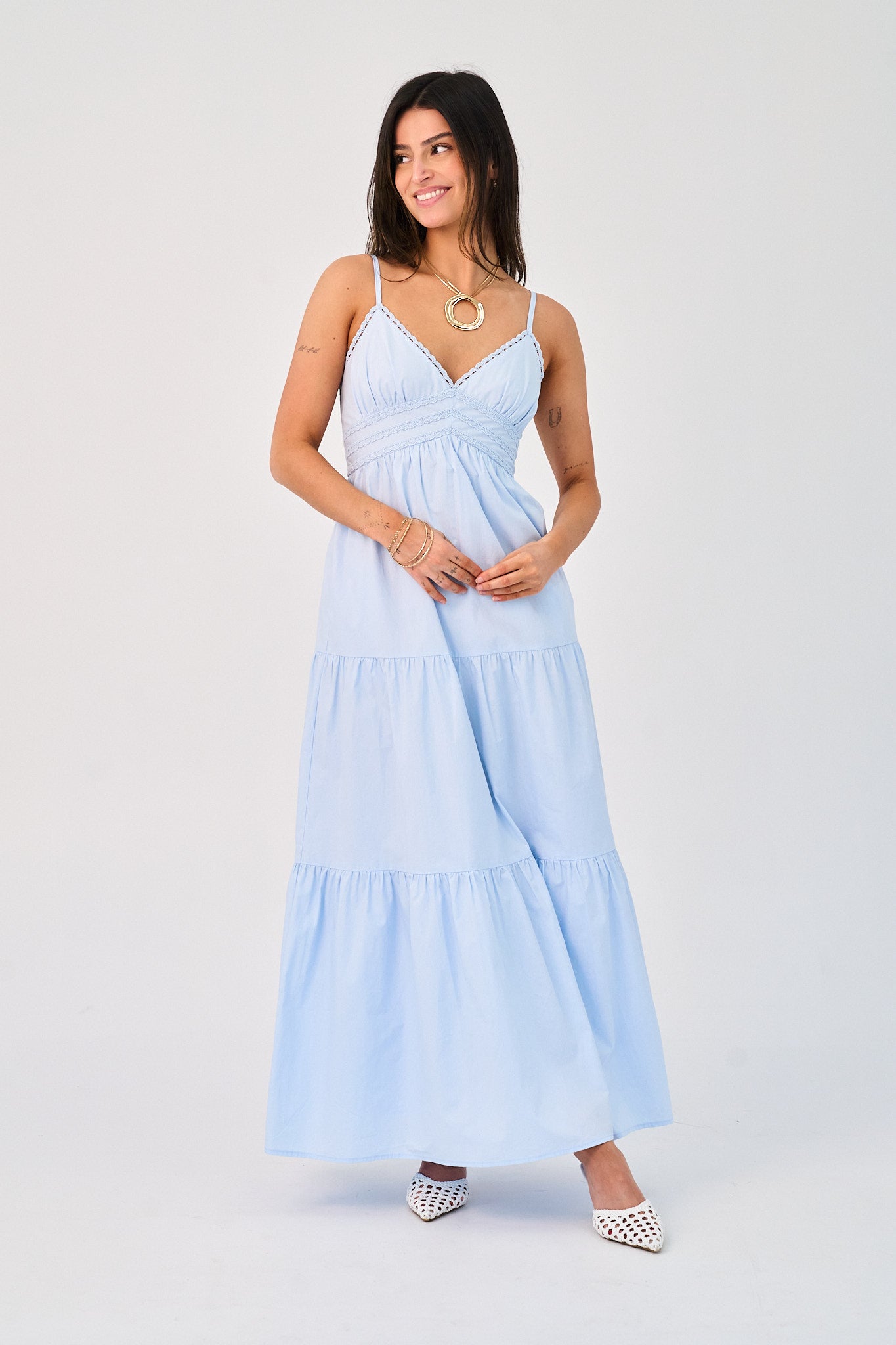 Woman wearing a light blue dress on a white background