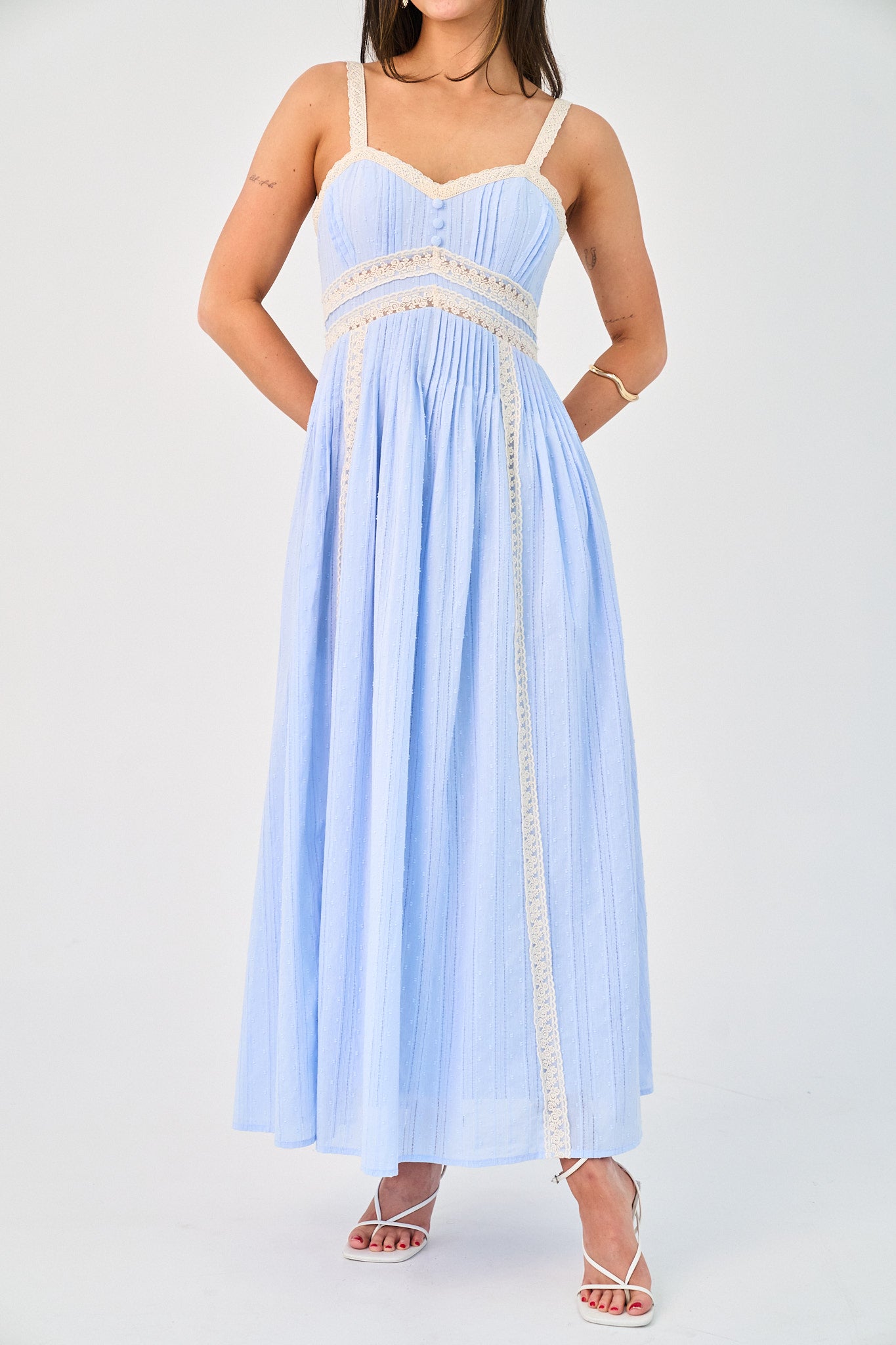 Light blue dress with white lace details on a white background