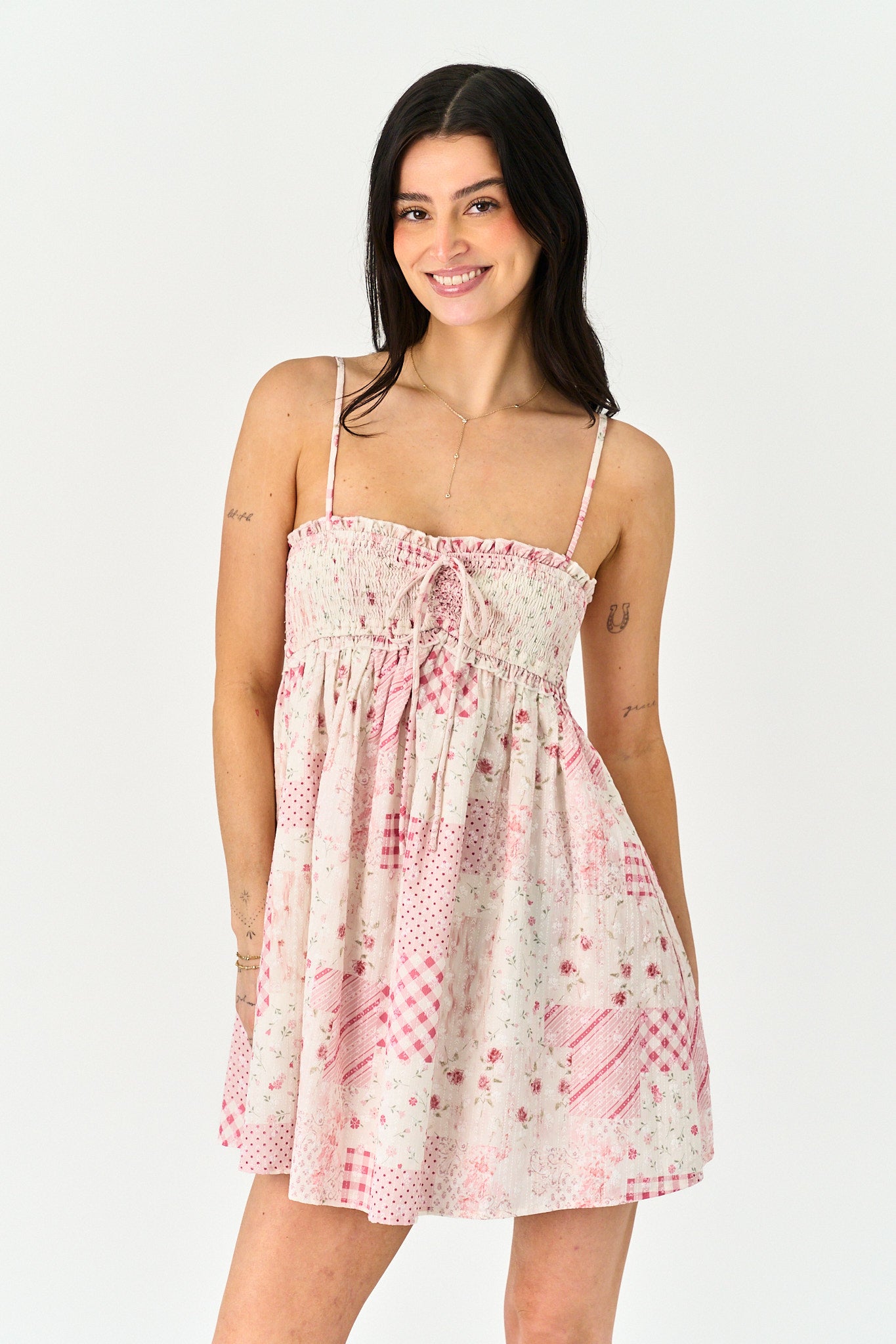 Woman wearing a patterned dress on a white background