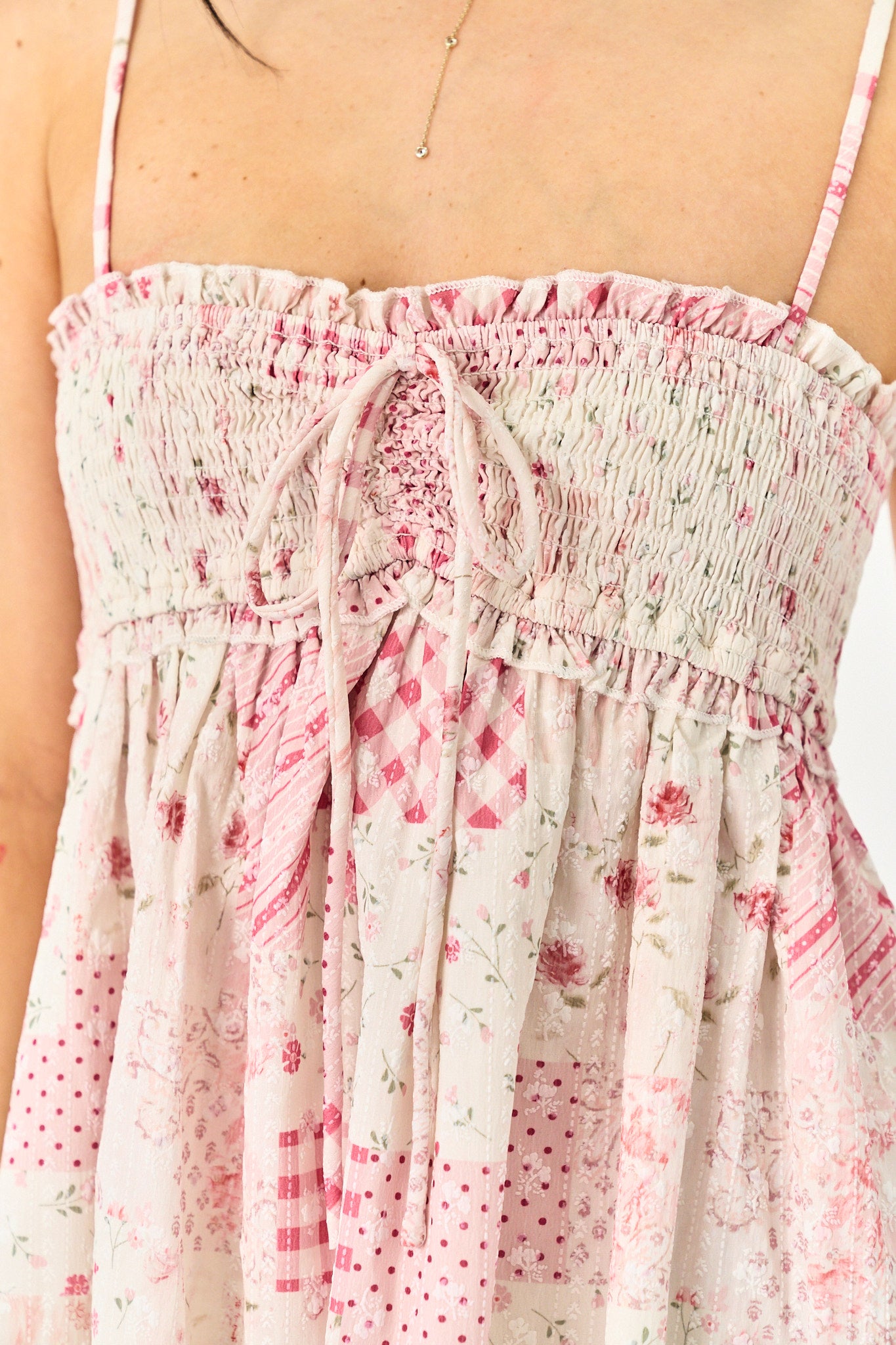 Floral dress with pink and white pattern on a plain background