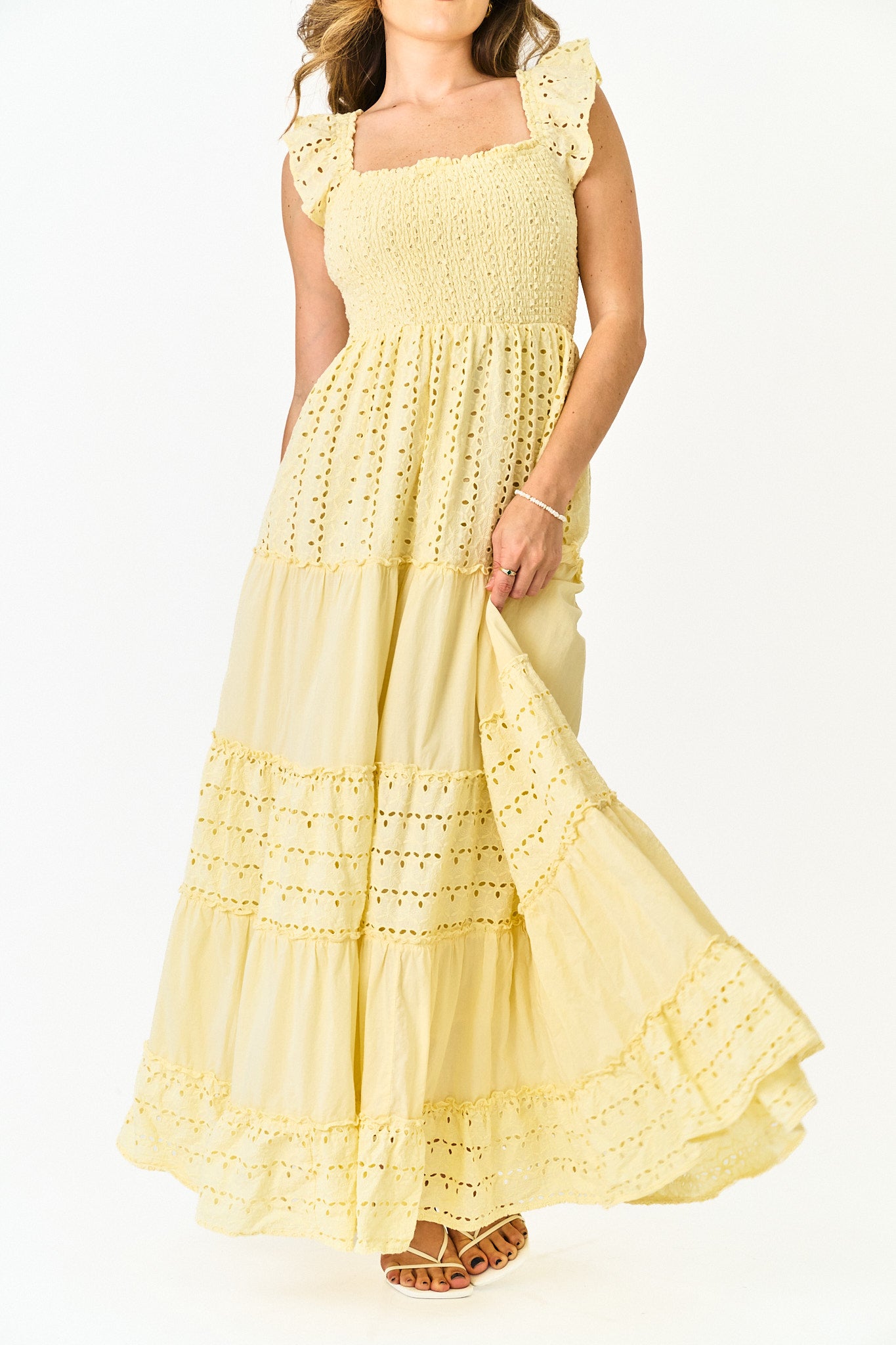 Yellow lace dress on a white background