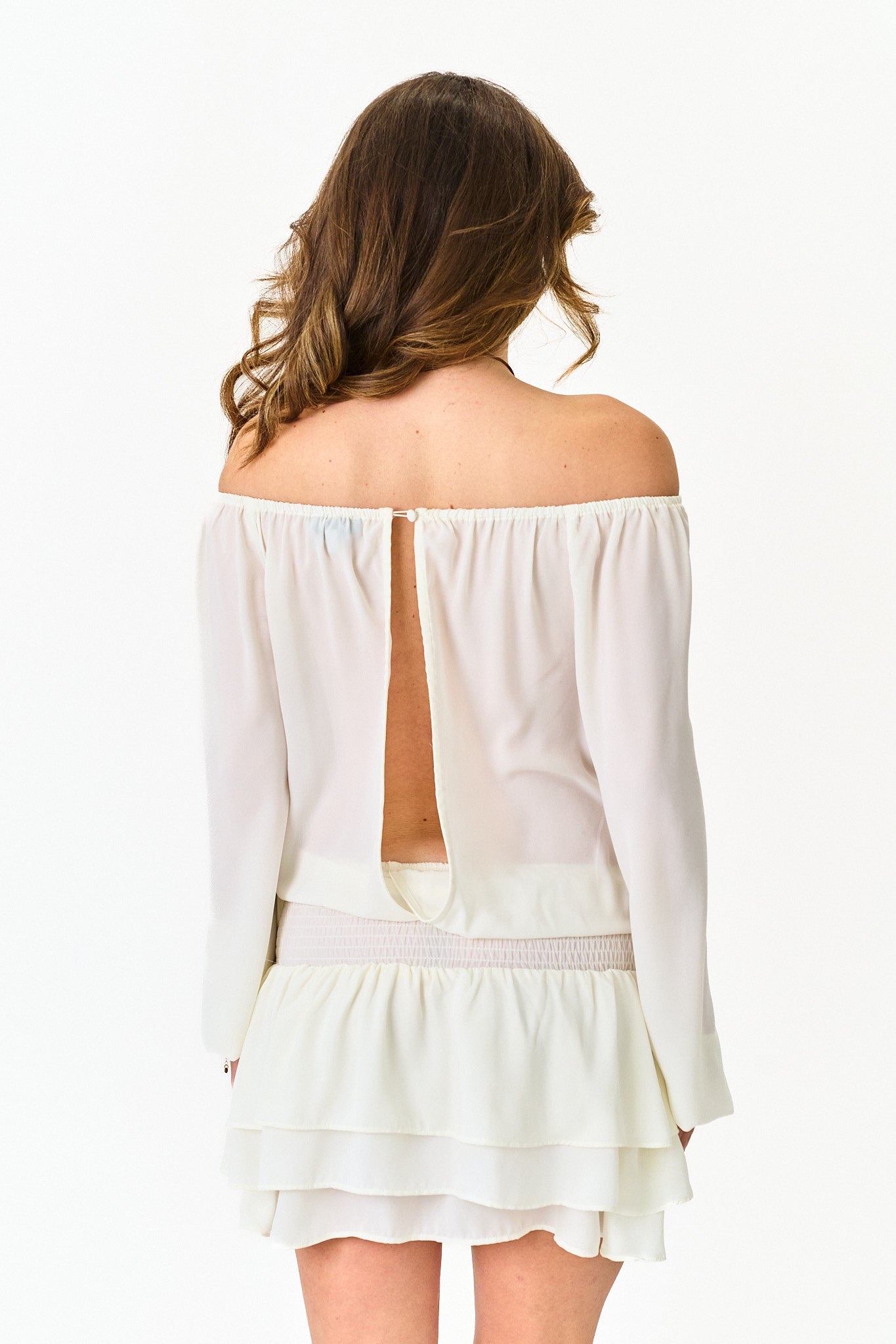 White off-shoulder dress with long sleeves on a white background