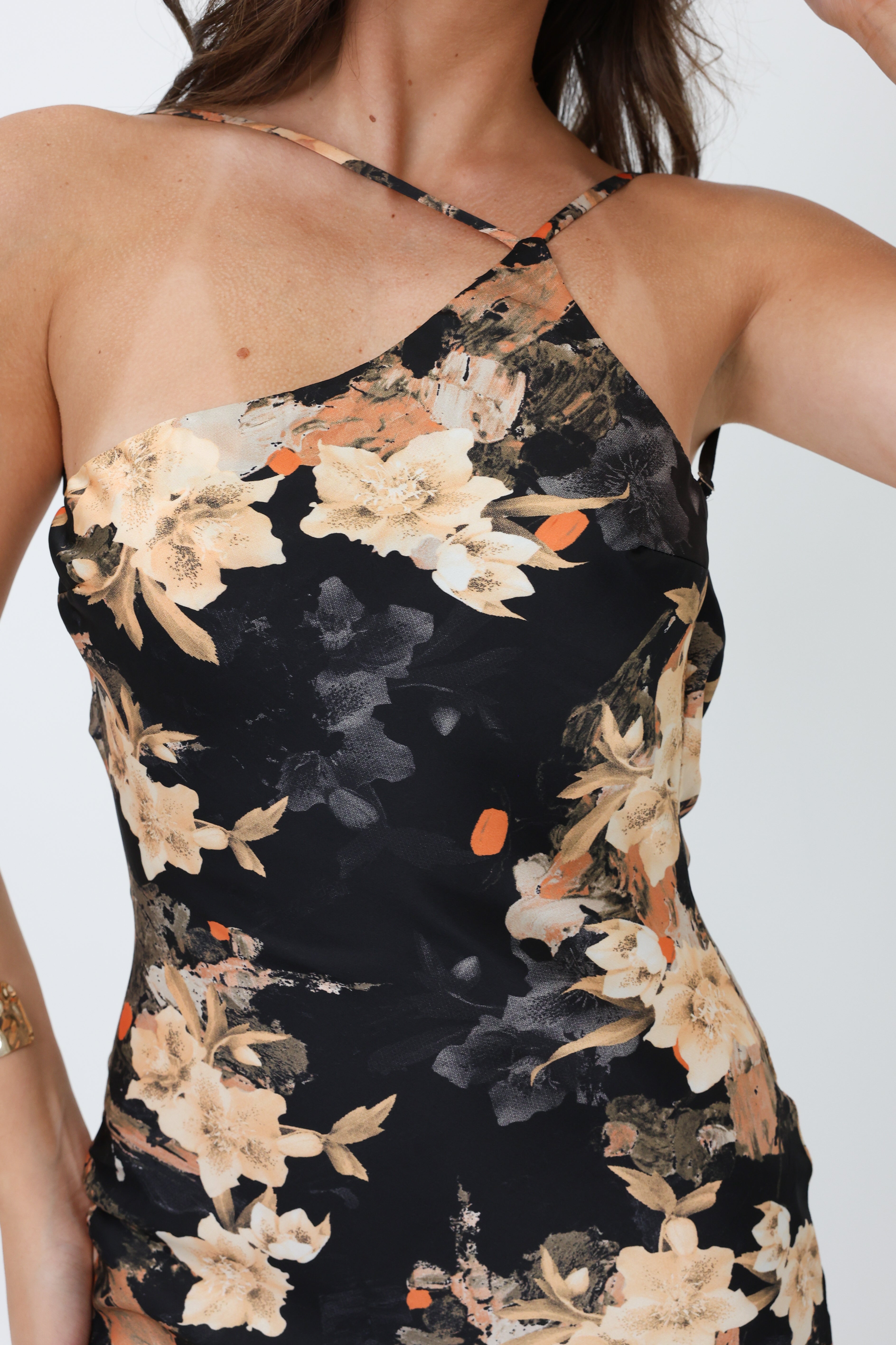 Black floral halter dress on a white background