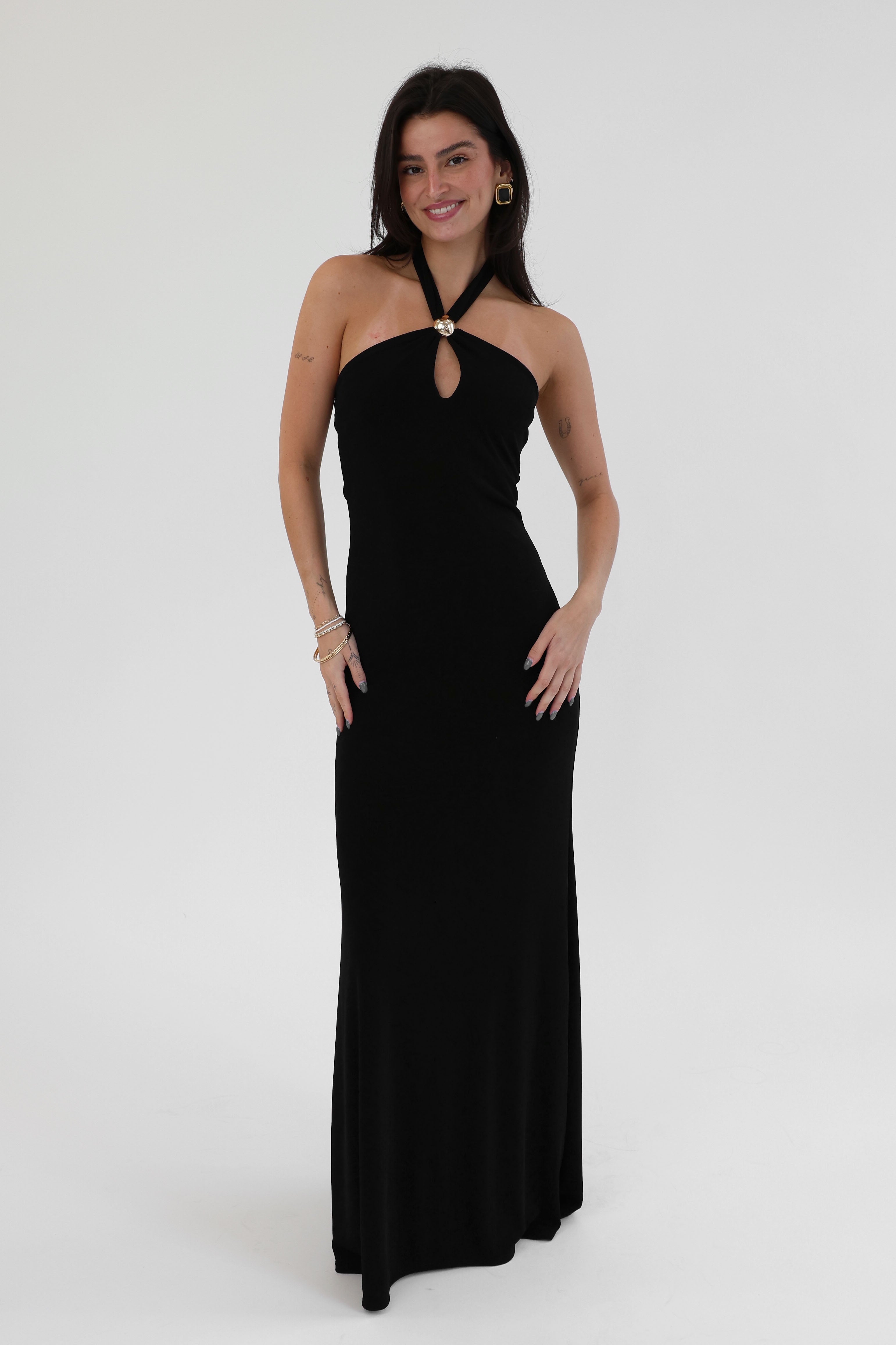 Woman wearing a black halter neck dress on a white background
