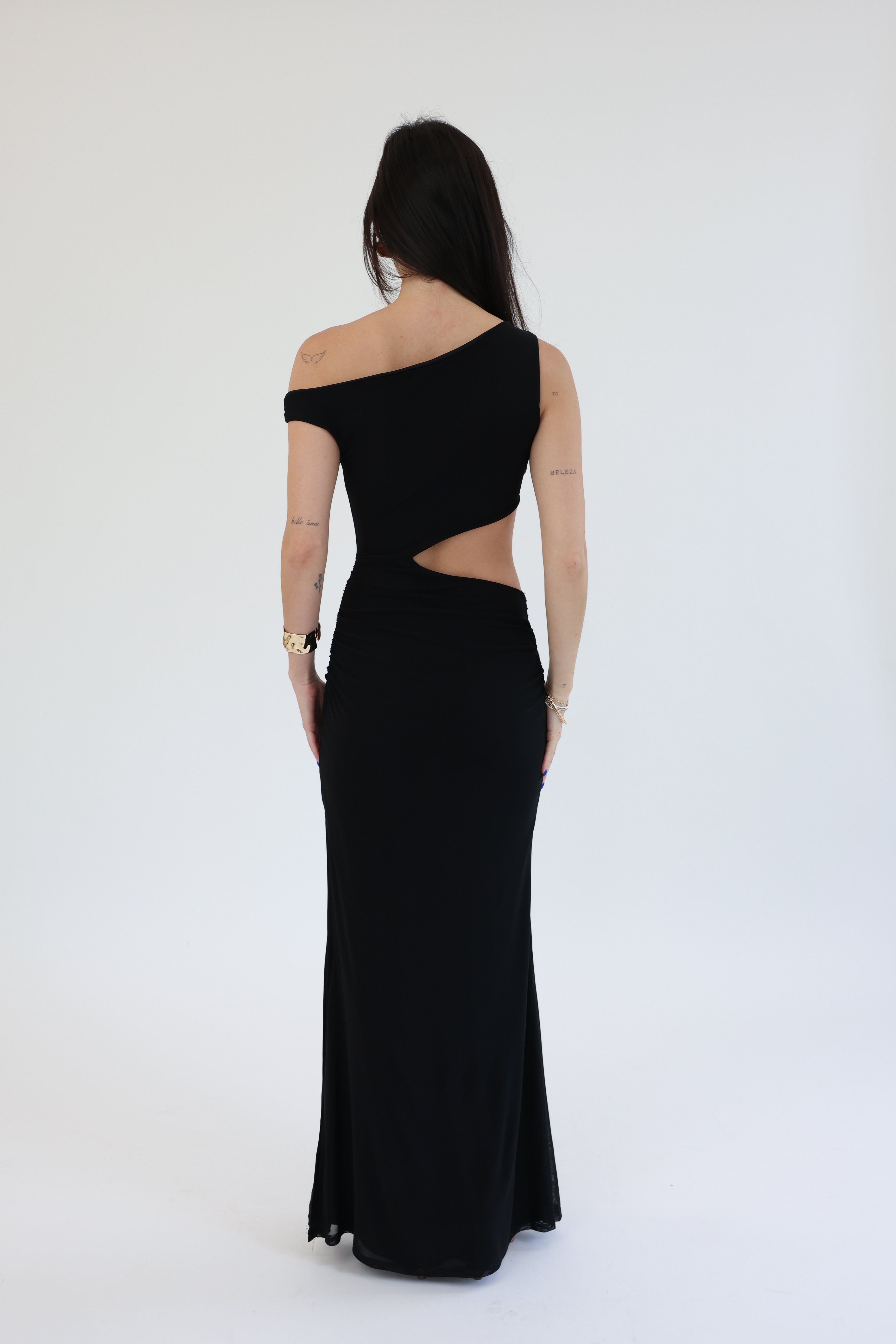 Black one-shoulder evening gown with cut-out design on a white background