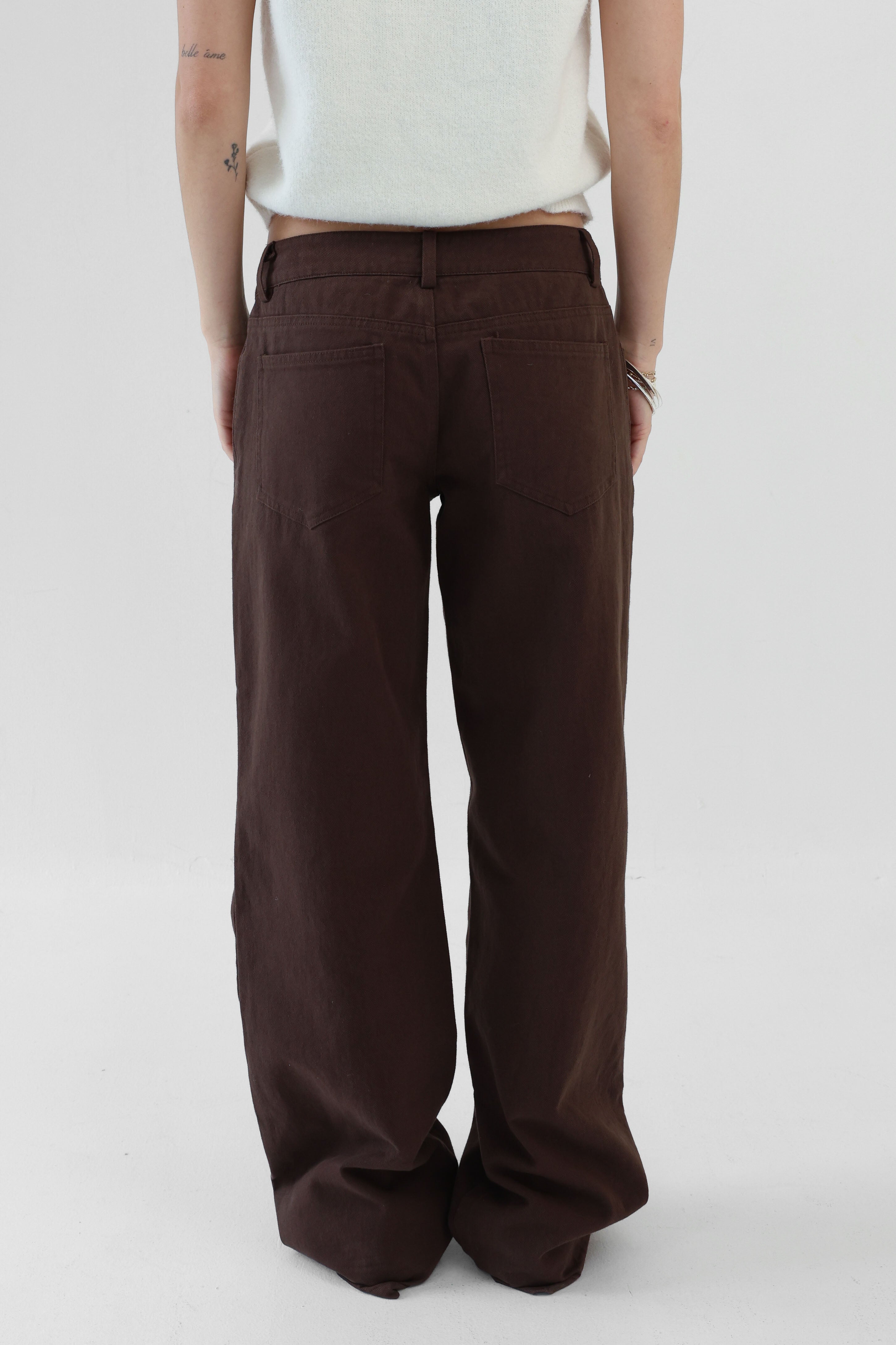 Brown wide-leg pants worn by a person on a white background