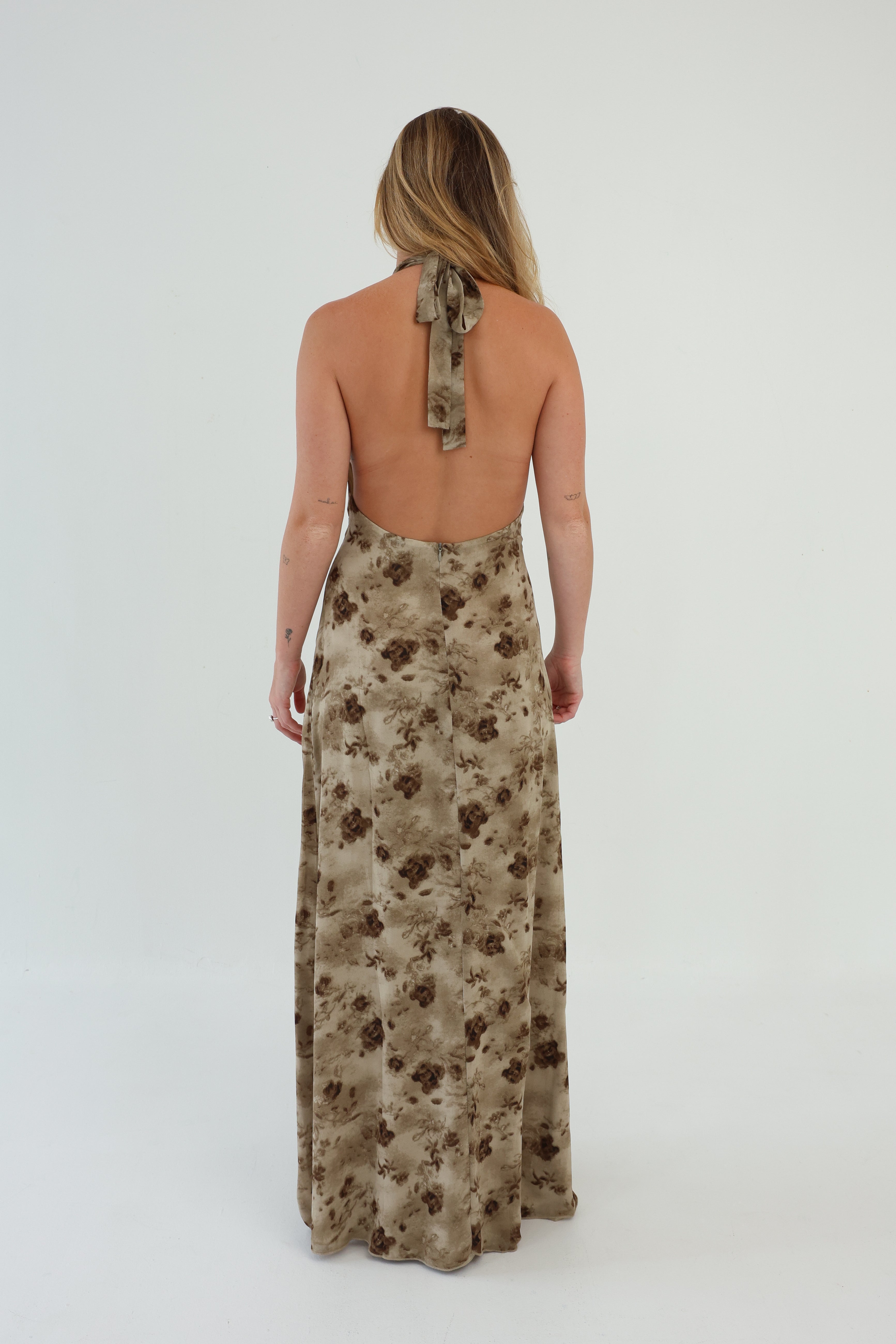 Woman wearing a floral dress with a plain background