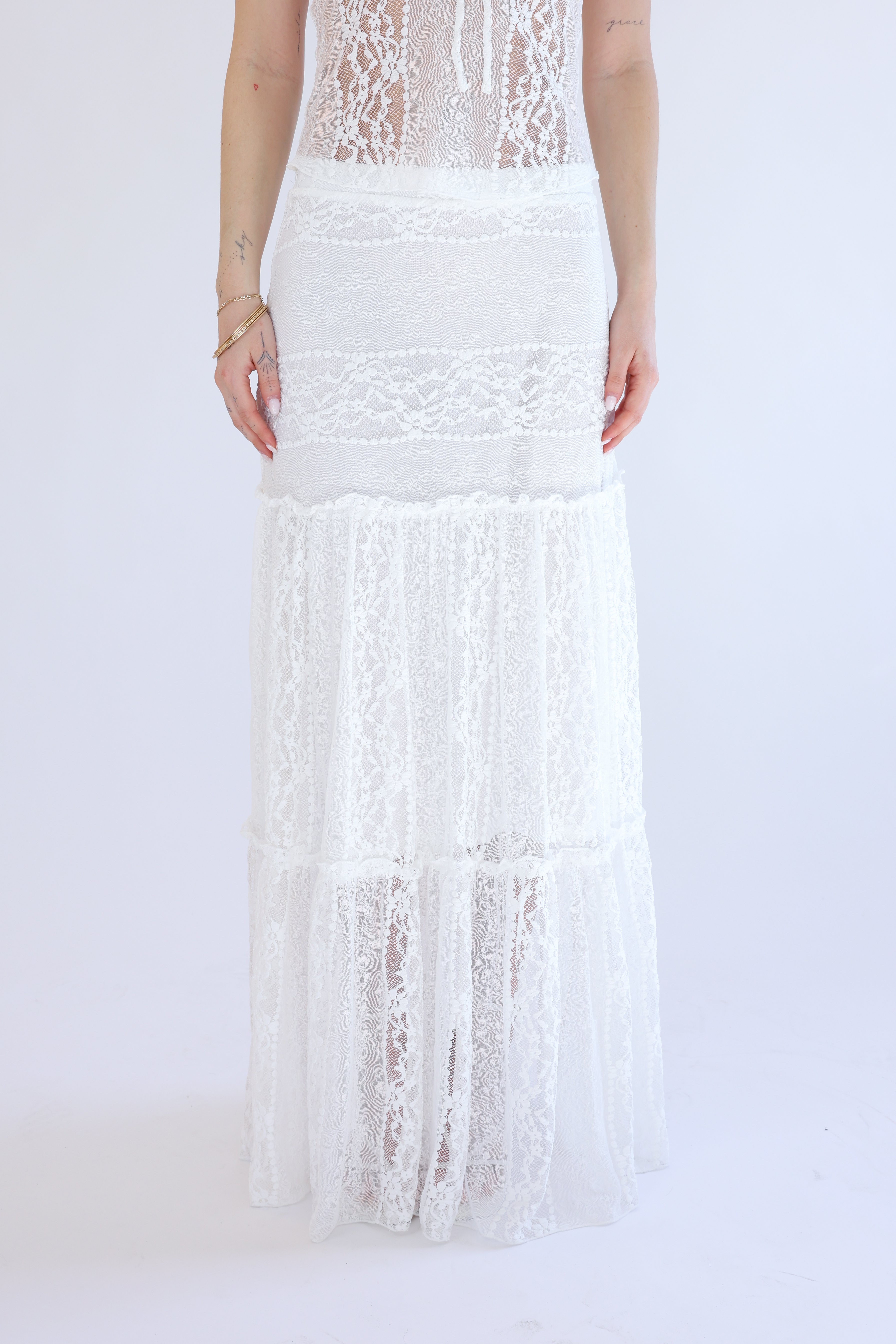 White lace skirt with fringe on a white background