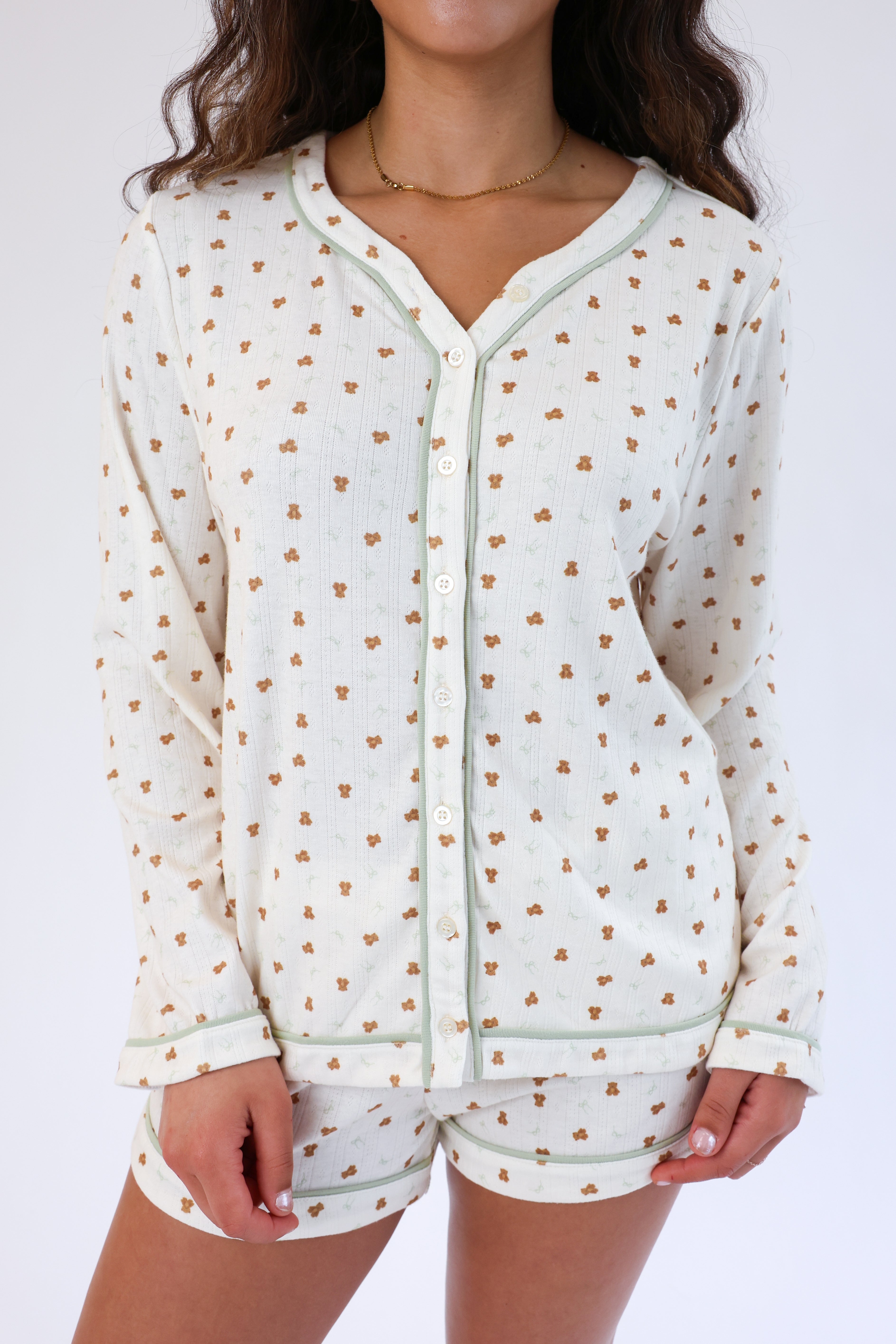 Light-colored pajama set with small pattern on a white background
