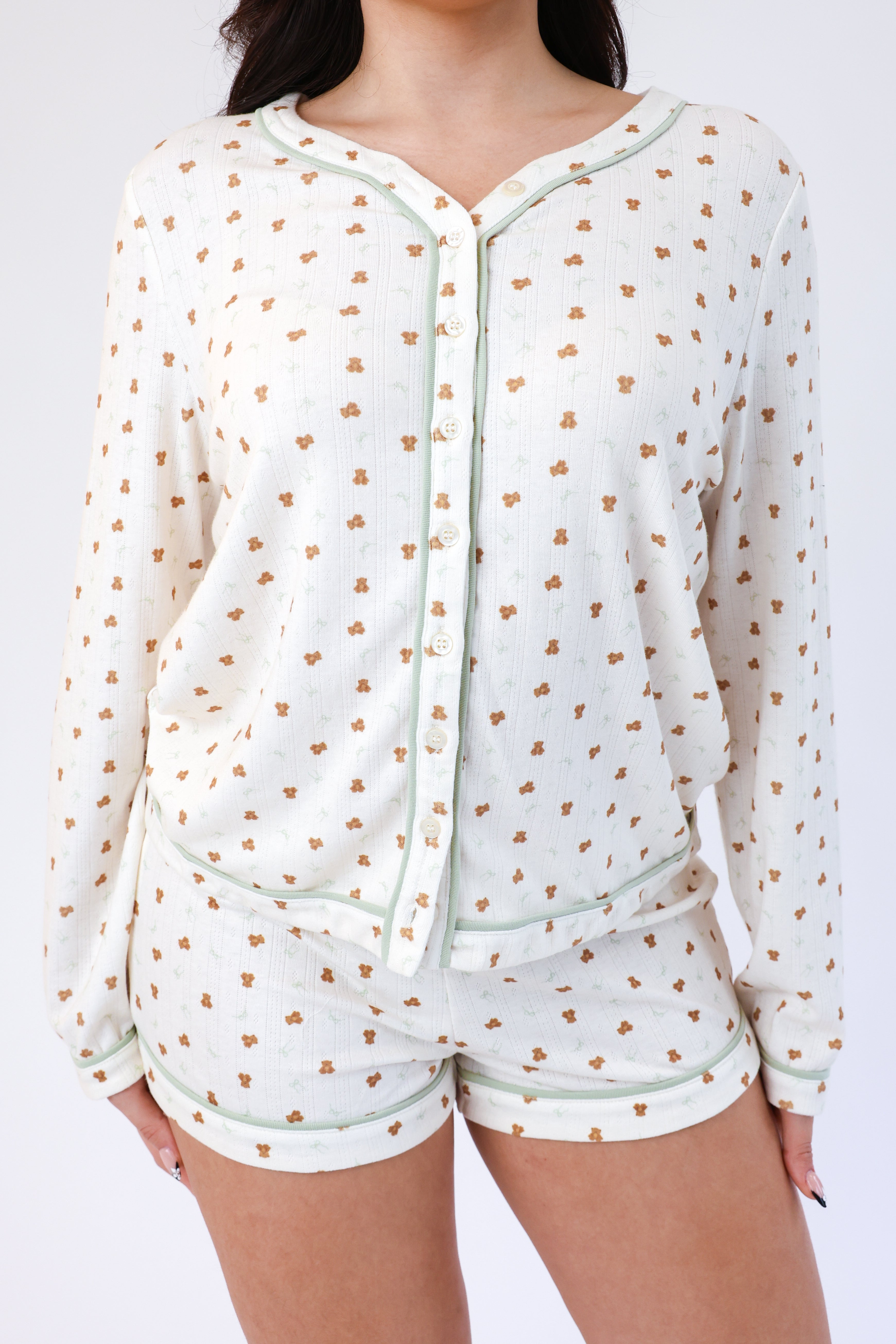 Light green pajama set with small patterns on a white background