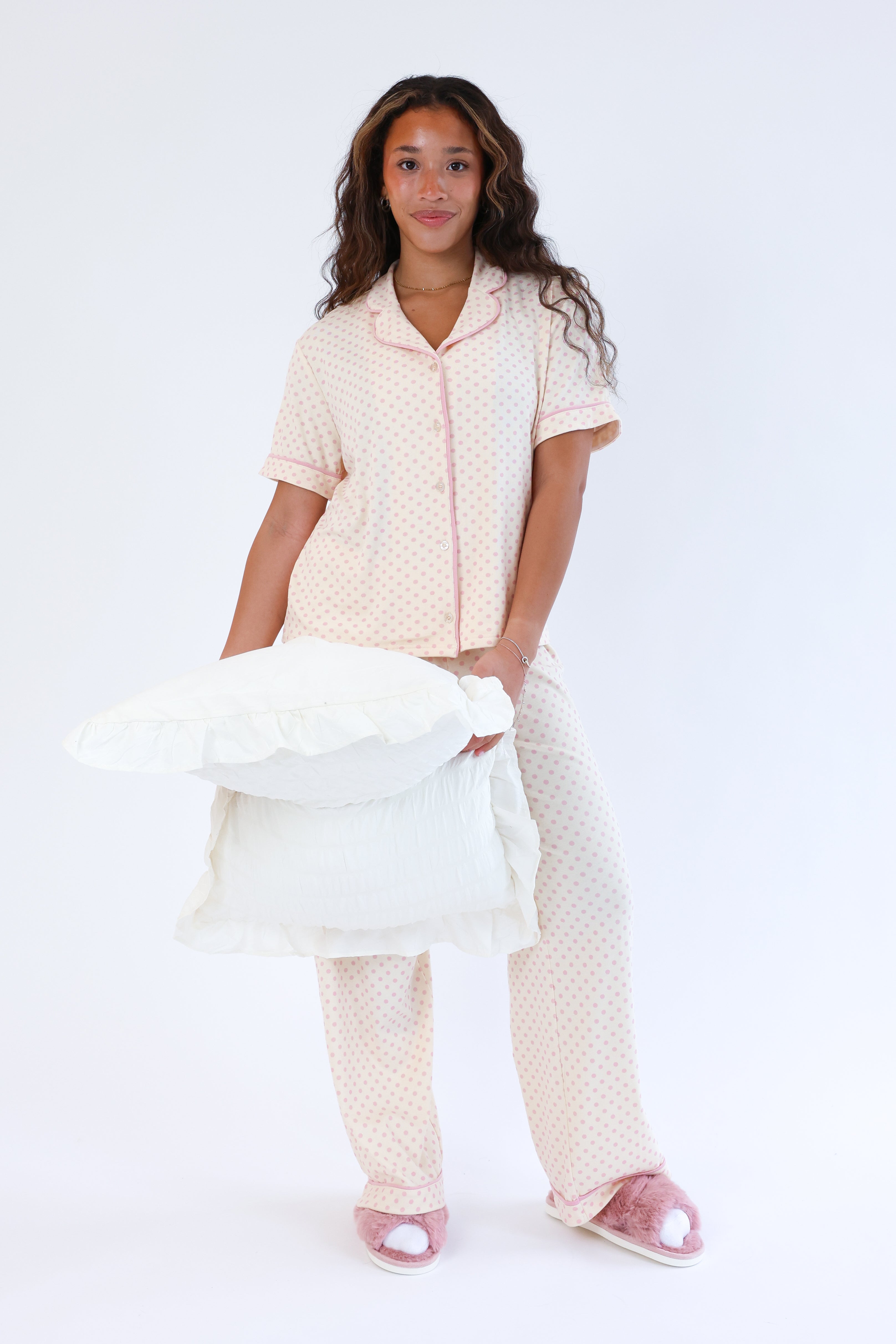 Woman wearing a matching pajama set with a white background