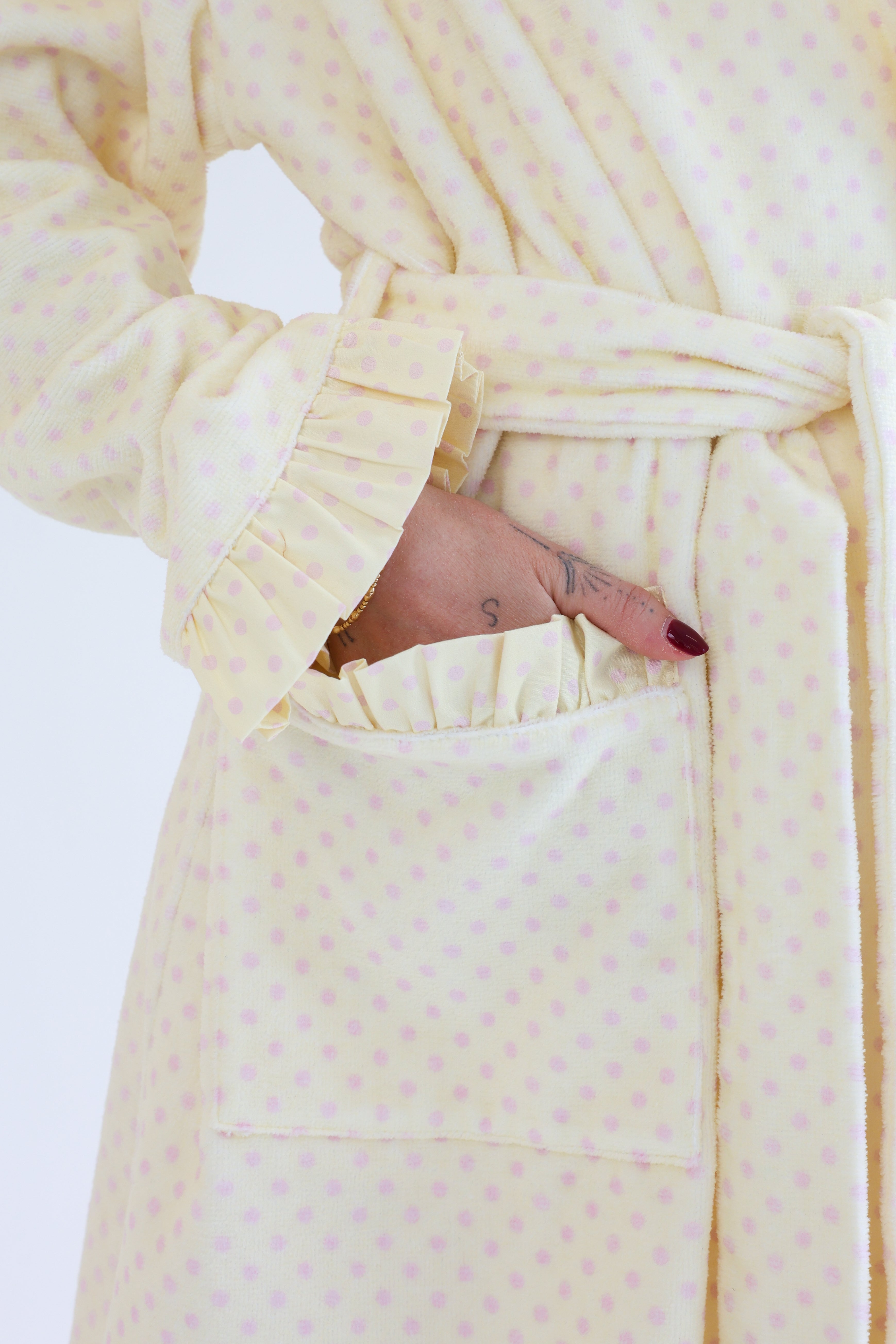 Cream-colored robe with a textured pattern on a white background