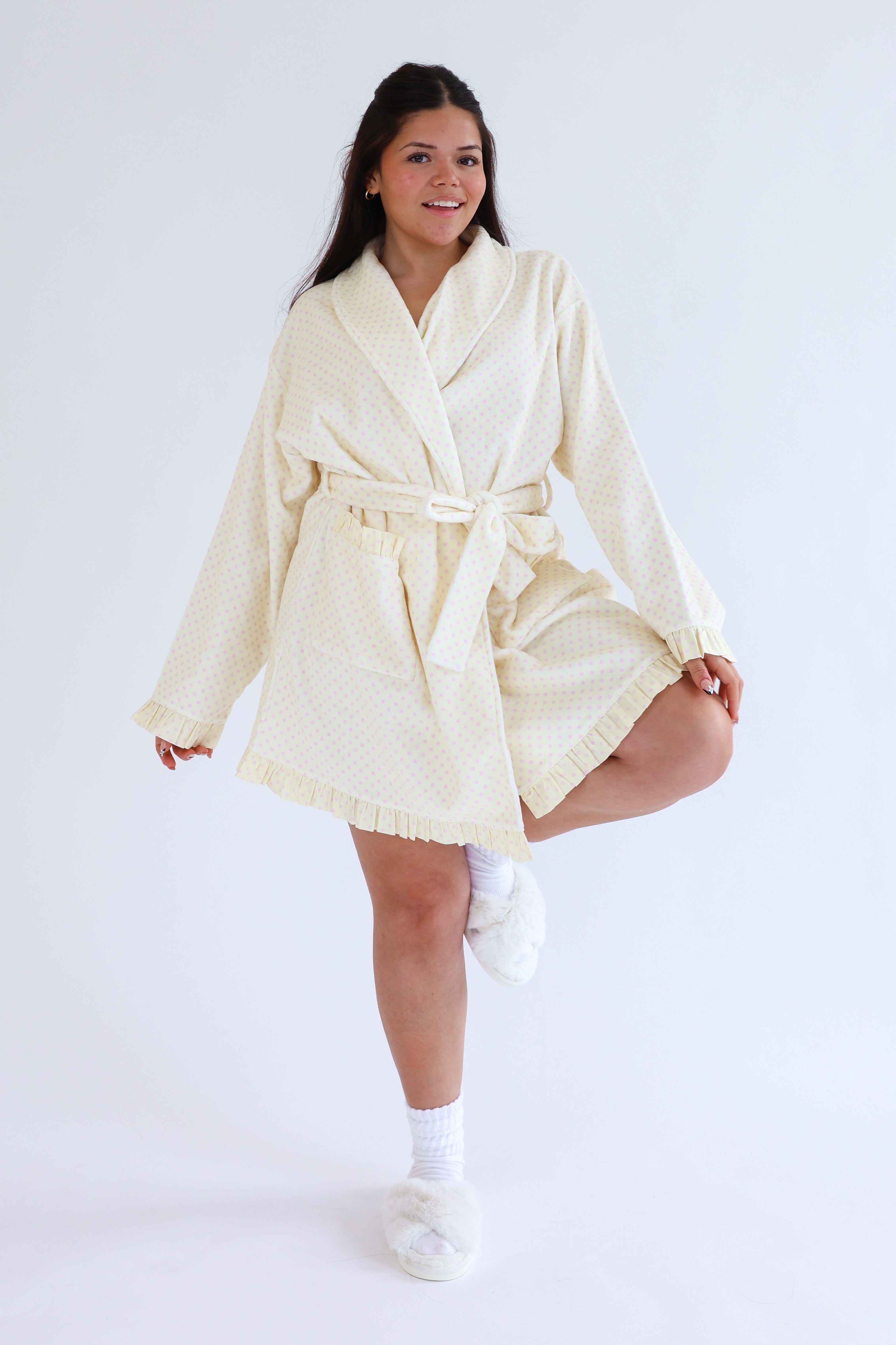 Woman wearing a cream-colored robe on a white background