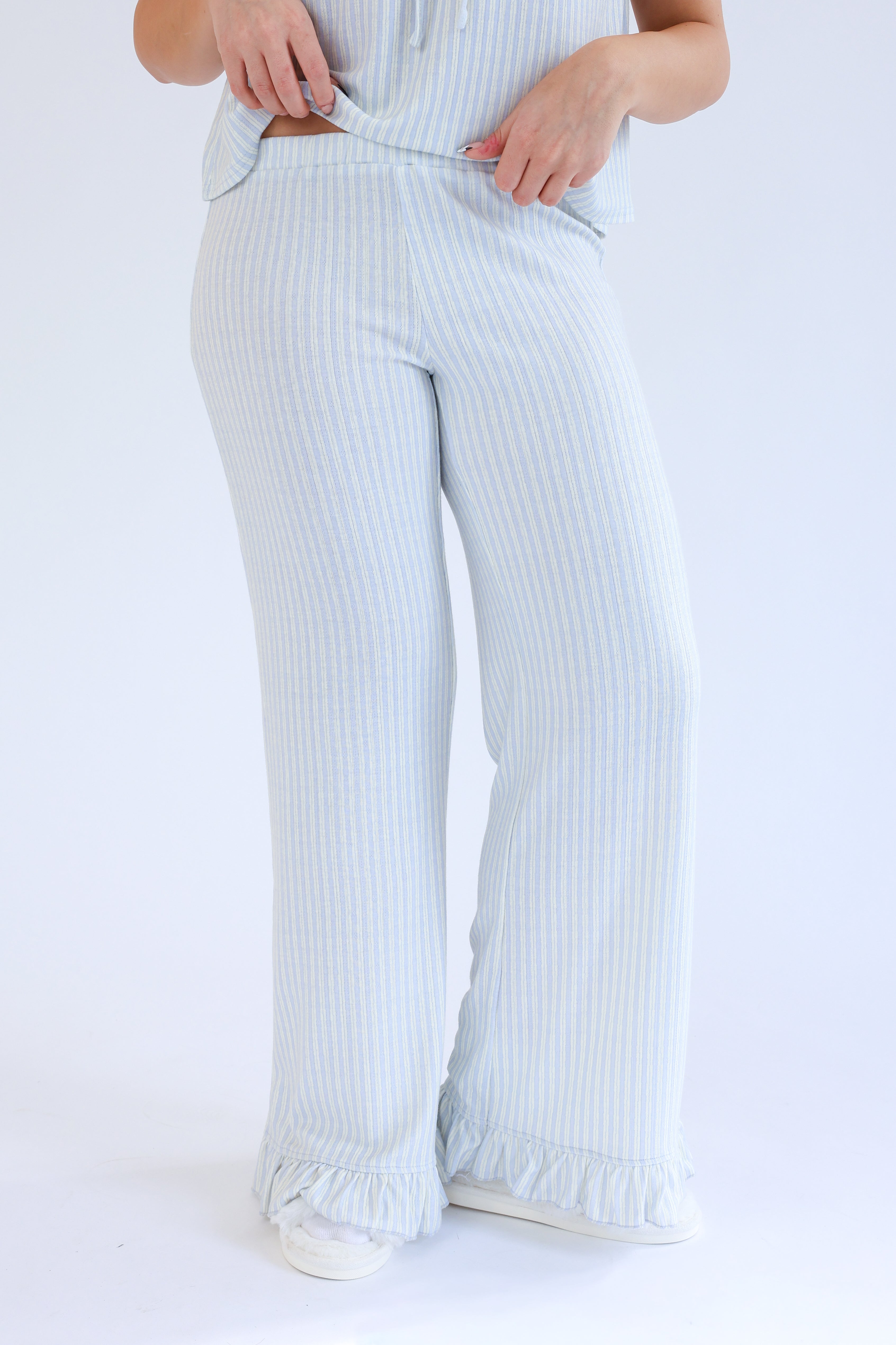 Light blue striped pants worn by a person on a white background