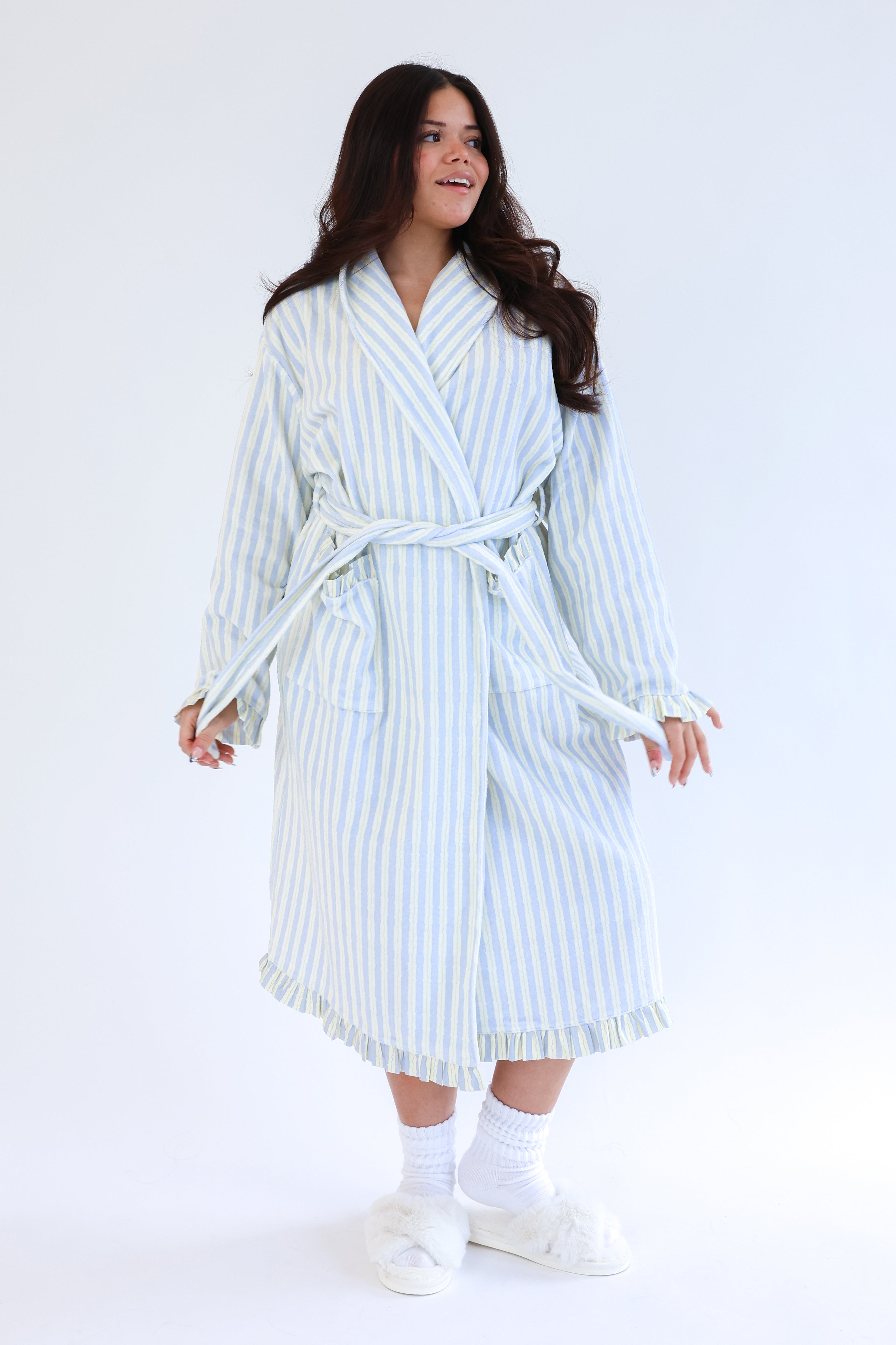 Woman wearing a striped robe on a white background