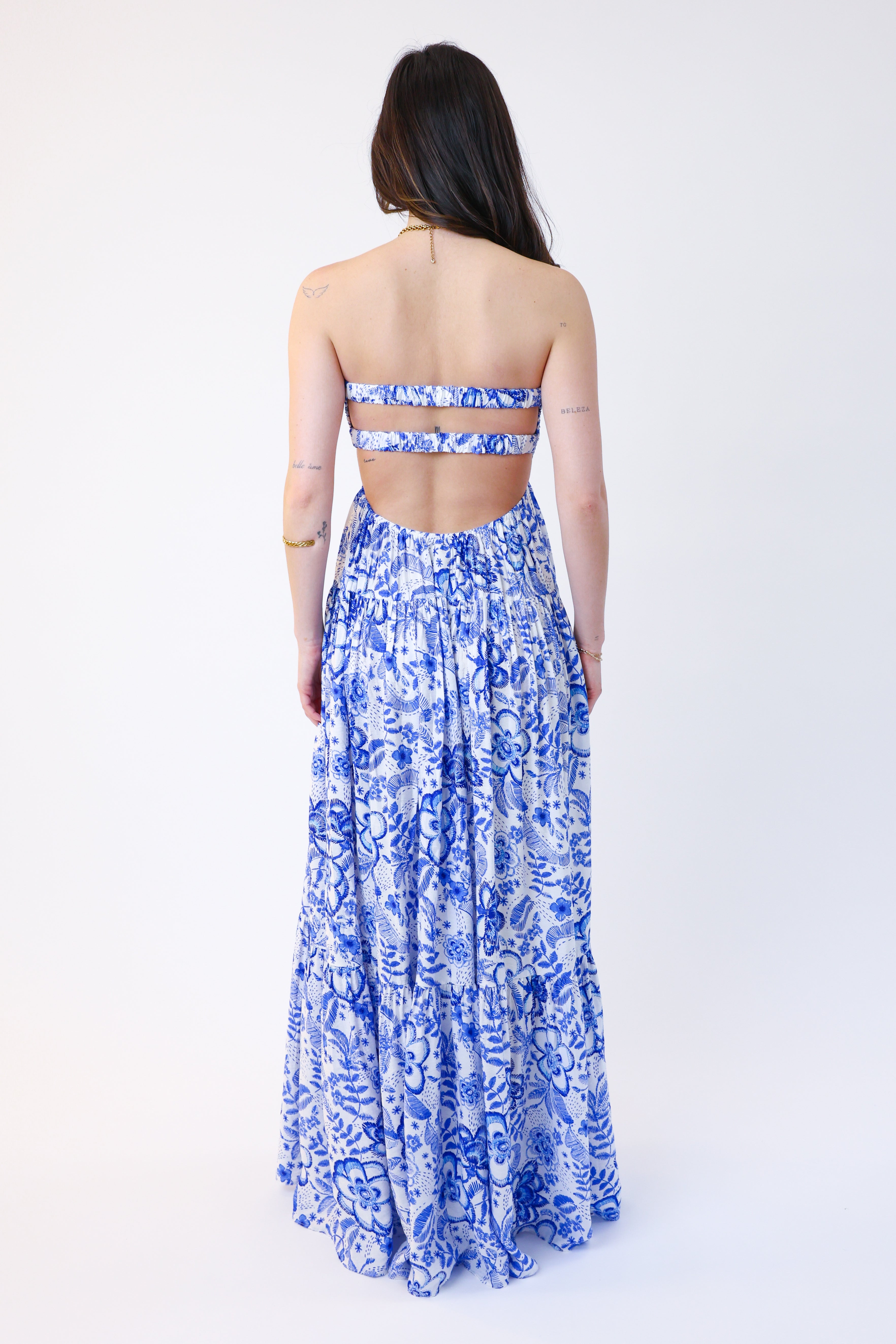 Woman wearing a blue floral dress on a white background