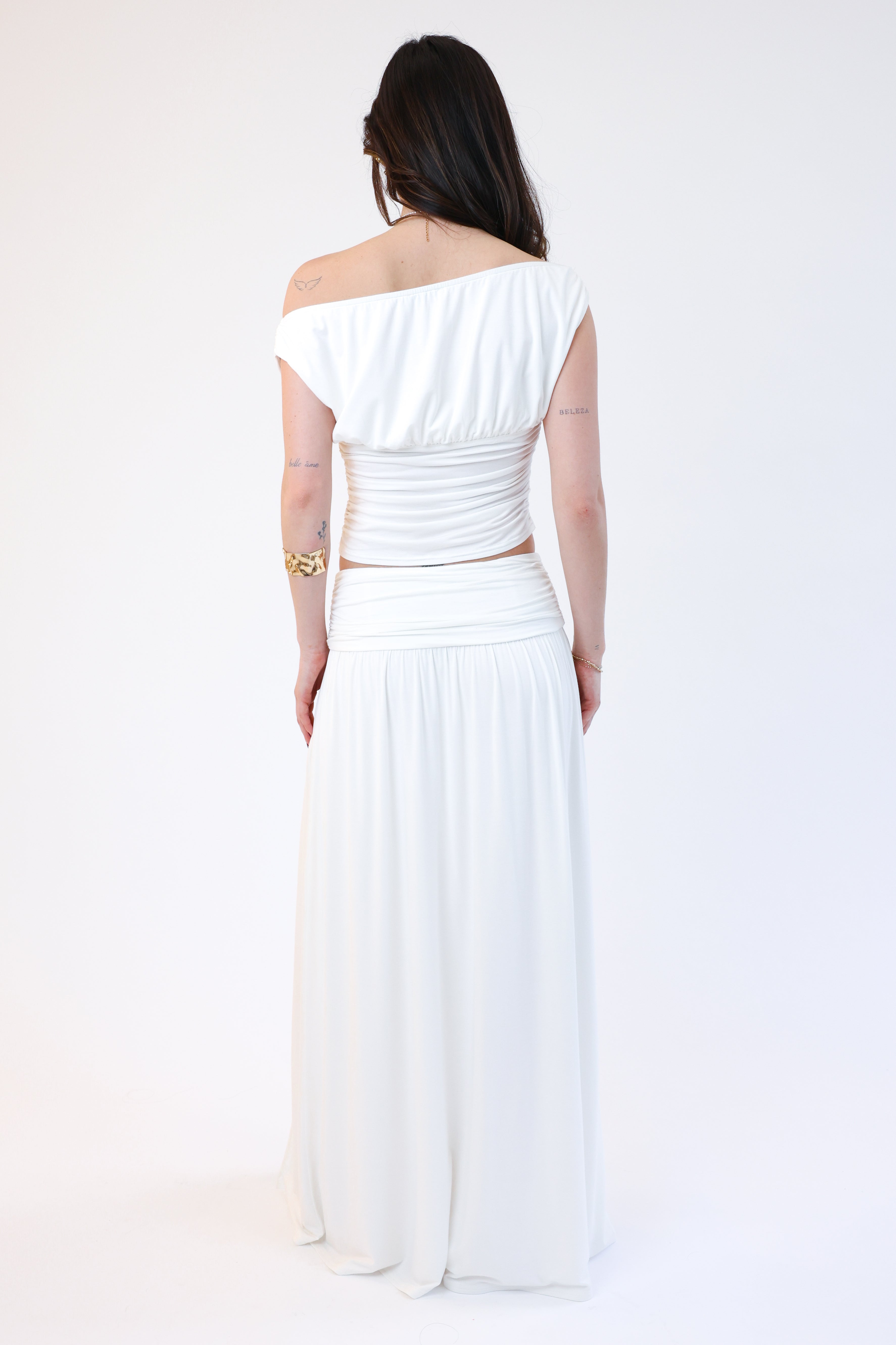 Woman wearing a white off-shoulder dress on a white background