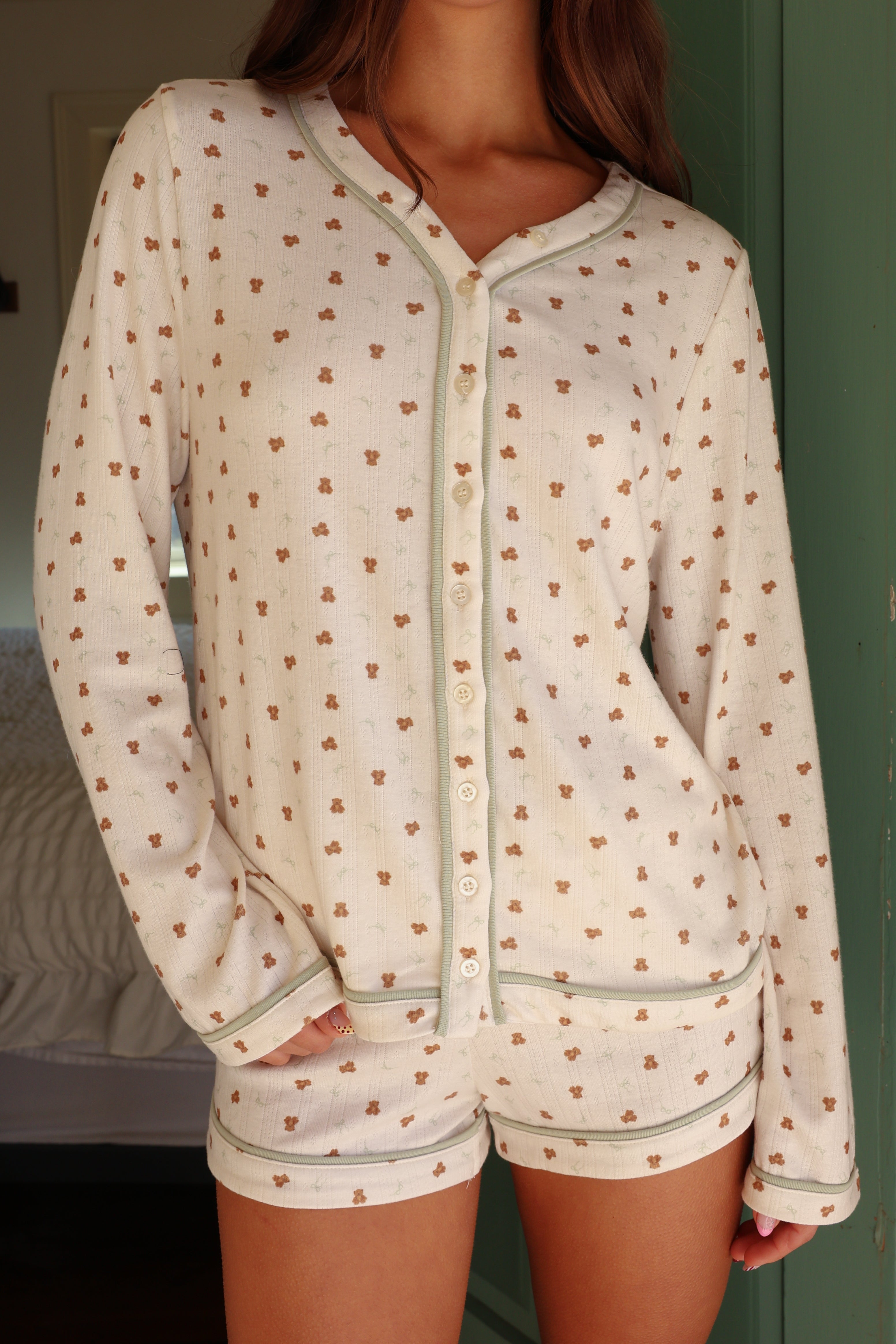 Light-colored pajama set with small pattern worn by a person.