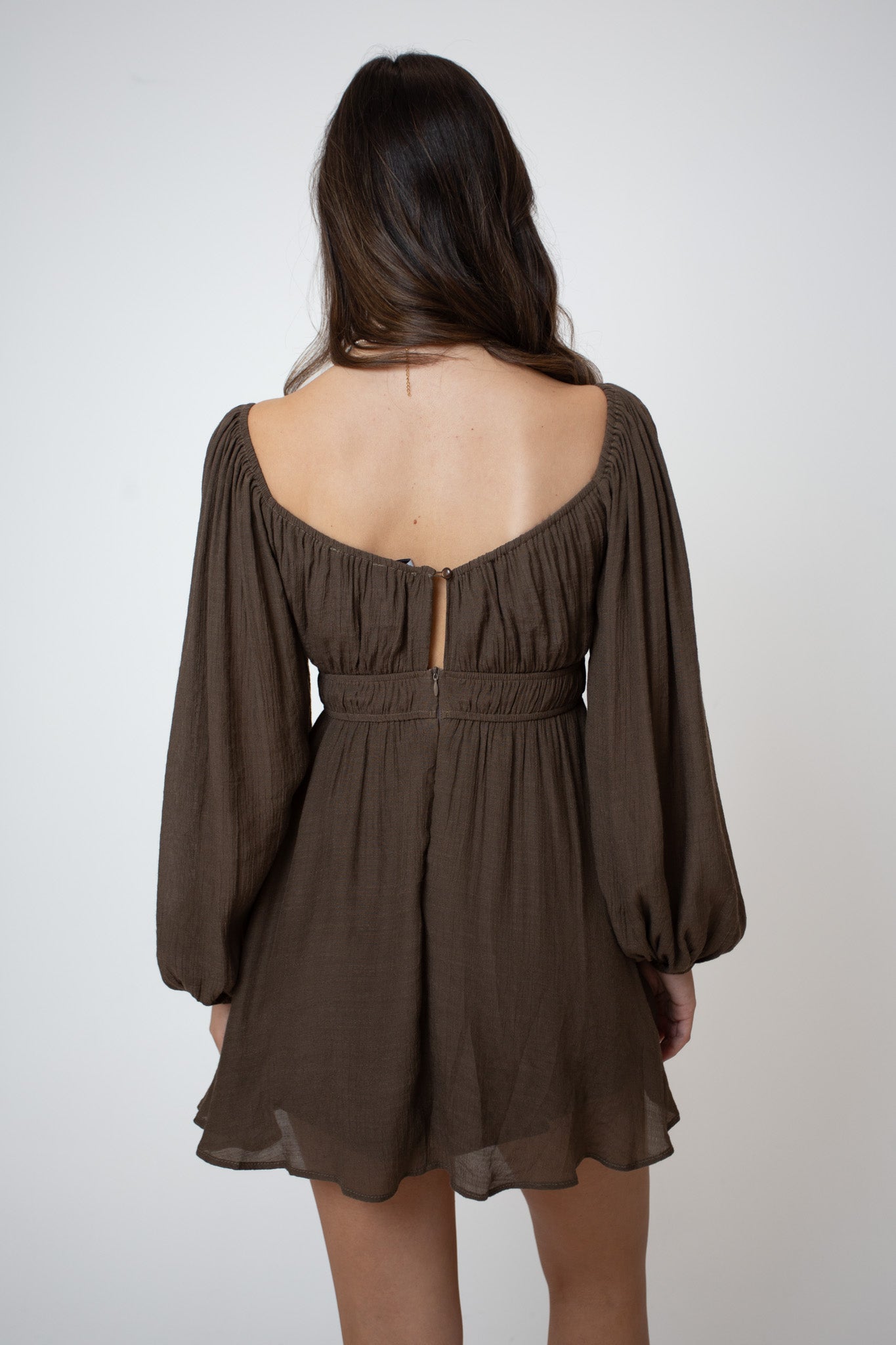Brown dress with long sleeves on a white background